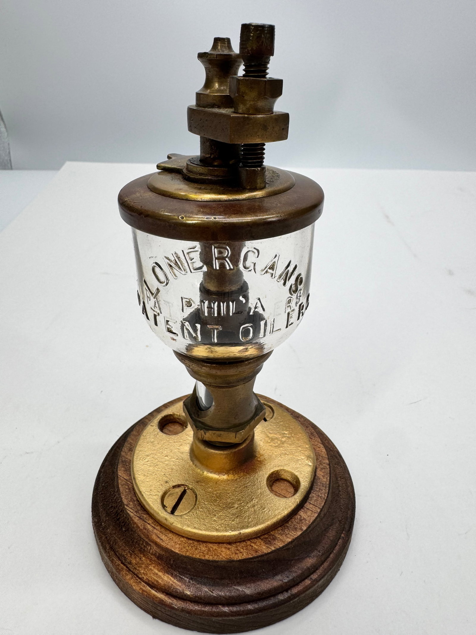 Antique Lonergan’s Patent Brass & Glass Steam Engine Oiler: Antique Lonergan’s Patent brass and glass oiler manufactured in Philadelphia, Pennsylvania, for use on steam engines, stationary engines, and other industrial machinery. Features a solid cast brass 