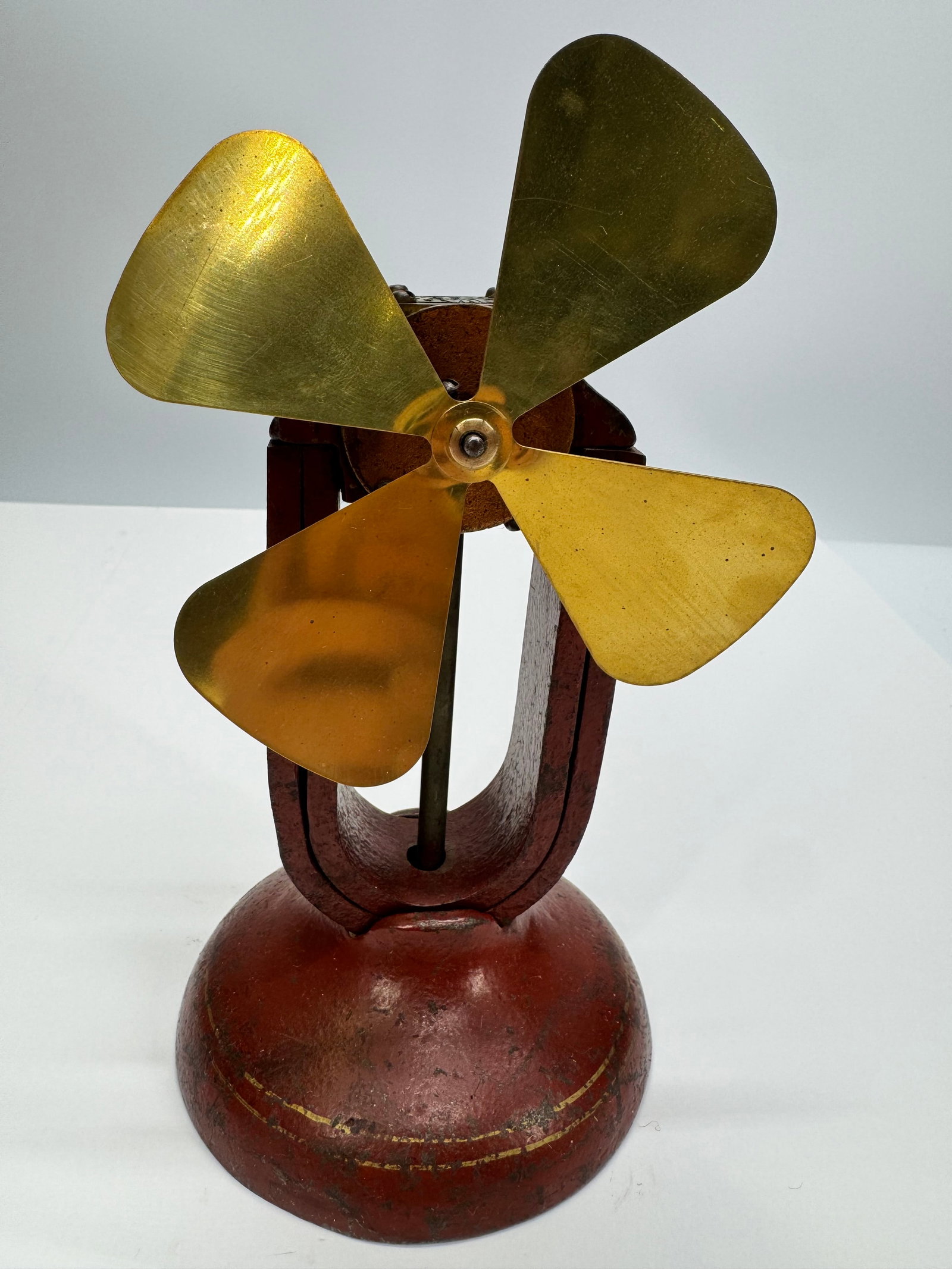Antique Manhattan No. 1 Electric Fan Motor Display: Antique Manhattan No. 1 Motor featuring an open-frame electric motor with polished brass four-blade fan and original red-painted cast iron base. Dating to the early 1900s, this classic demonstration o