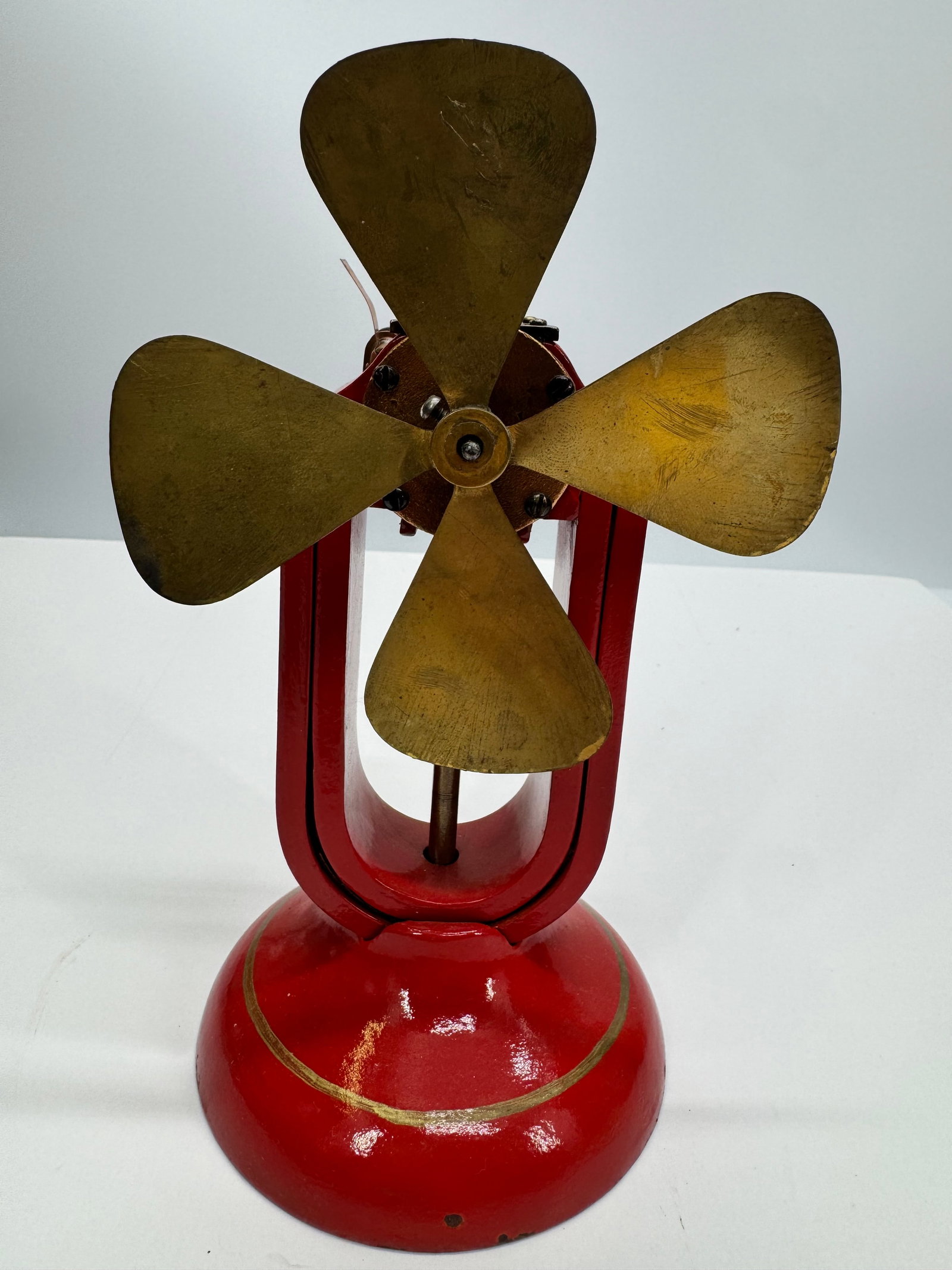 Antique Manhattan No. 1 Electric Fan Motor Brass Blade: Antique Manhattan No. 1 Motor featuring a four-blade brass fan, red-painted cast iron frame, and open-frame electric motor. Manufactured in the early 1900s, this classic electric fan motor showcases e
