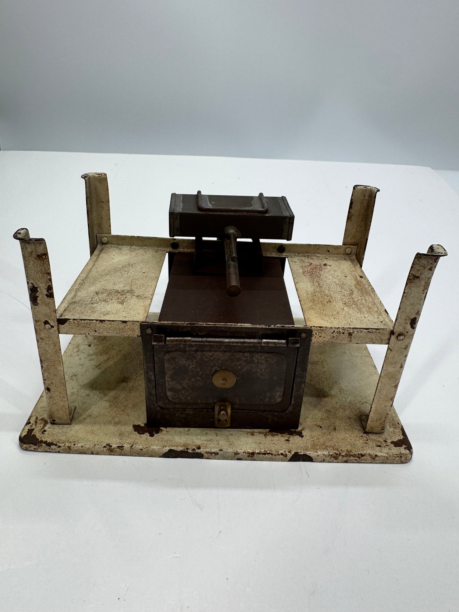 Antique Salesman Sample Cast Iron Cook Stove Display: Antique salesman sample cast iron cook stove, dating to the late 19th or early 20th century. This miniature display model features a cast iron firebox with opening oven door, removable top warming box