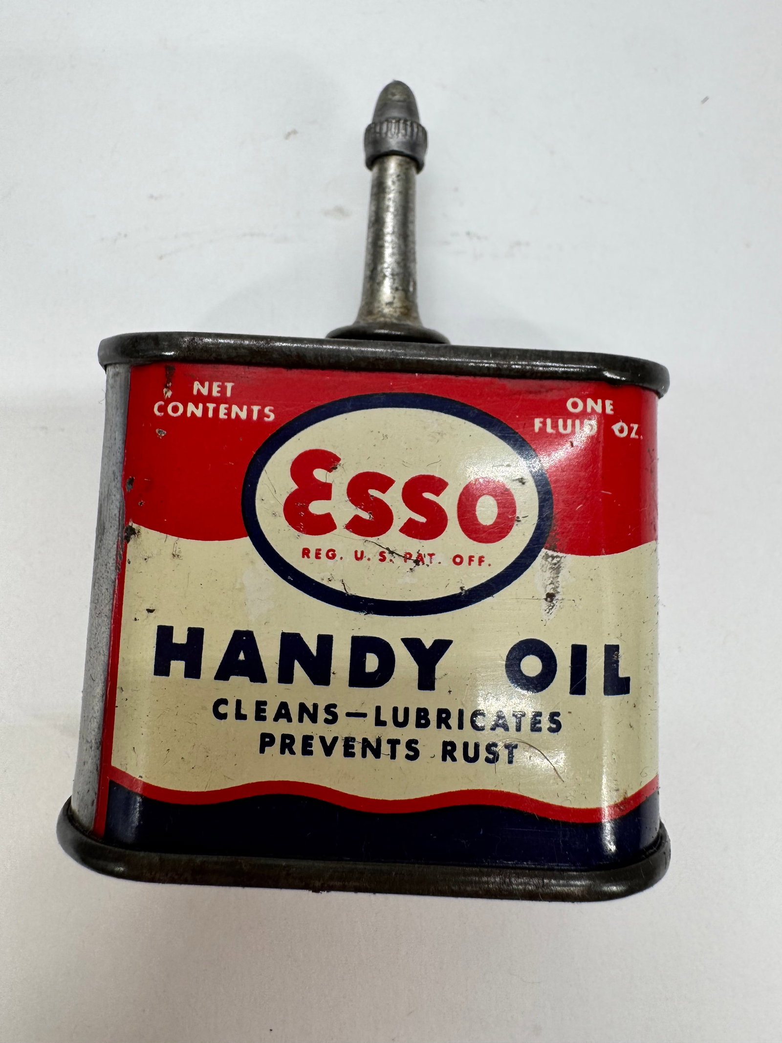 Vintage Esso Handy Oil 1 Oz Tin Oiler Bayway New Jersey: Vintage Esso Handy Oil 1-fluid-ounce tin oiler featuring the classic red, white, and blue Esso graphics. Manufactured in Bayway, New Jersey, this original metal oil can was designed for household and 