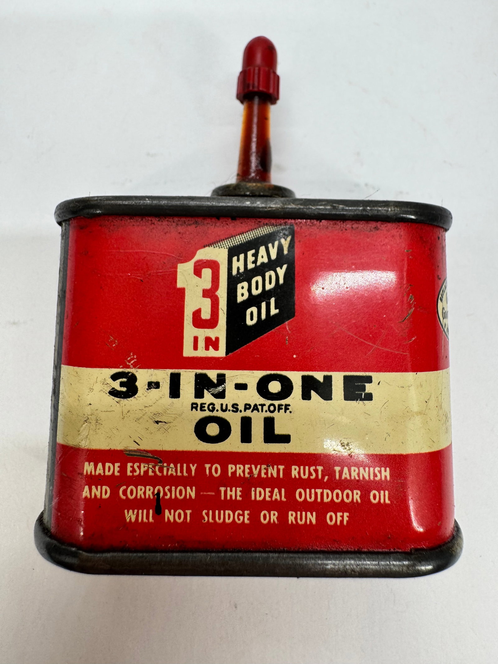 Vintage 3-In-One Heavy Body Oil Tin Oiler Advertising Can: Vintage 3-In-One Heavy Body Oil tin oiler featuring the classic red, black, and cream advertising graphics with its original red applicator cap. Designed to prevent rust, tarnish, and corrosion, this 