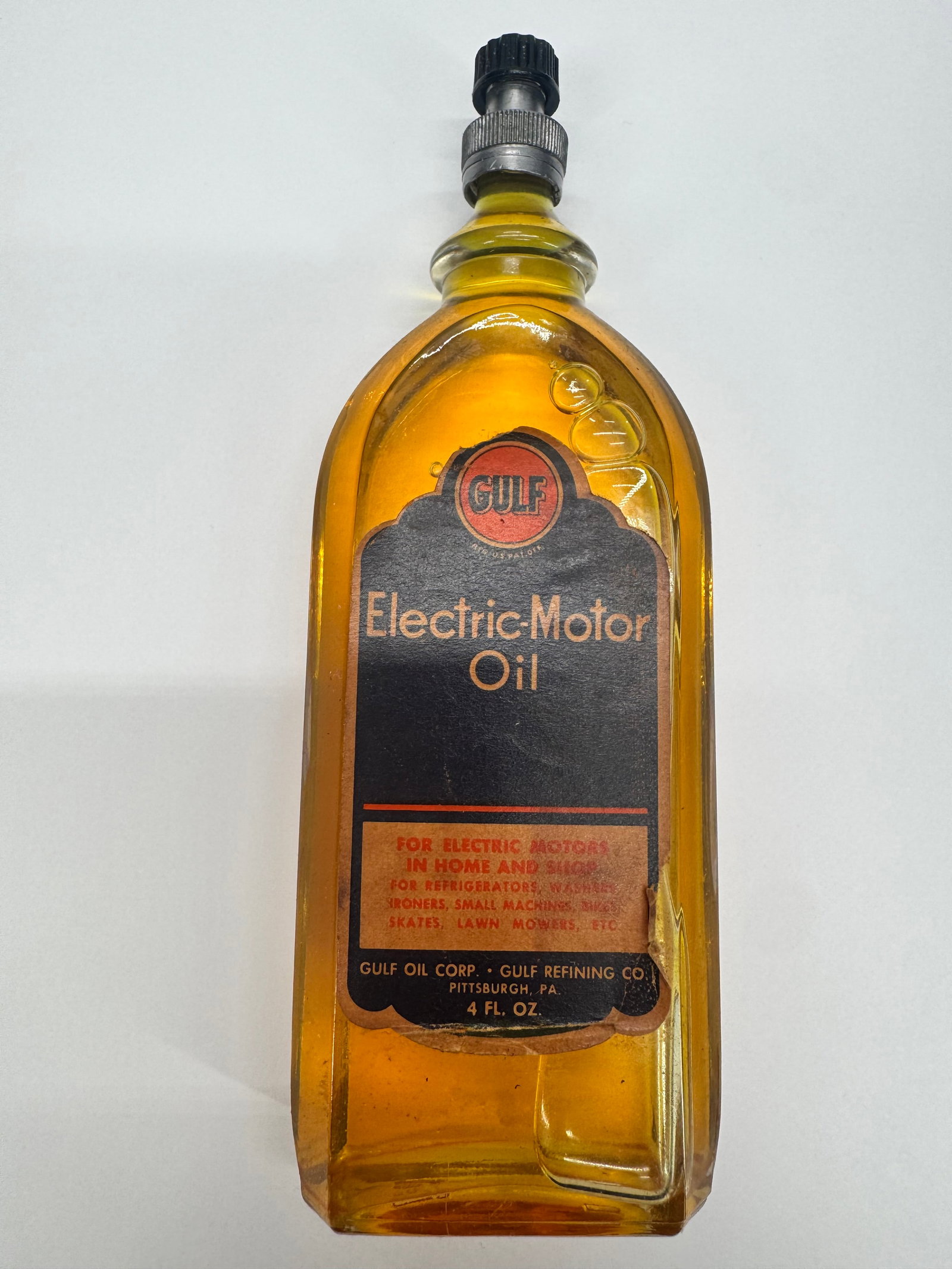 Vintage Gulf Electric Motor Oil 4 Oz Amber Glass Bottle w/ Oiler Cap: Vintage Gulf Electric Motor Oil amber glass bottle with original paper label and metal oiler cap. Marked 4 Fl. Oz. and manufactured for Gulf Oil Corp. / Gulf Refining Co., Pittsburgh, PA. Designed for
