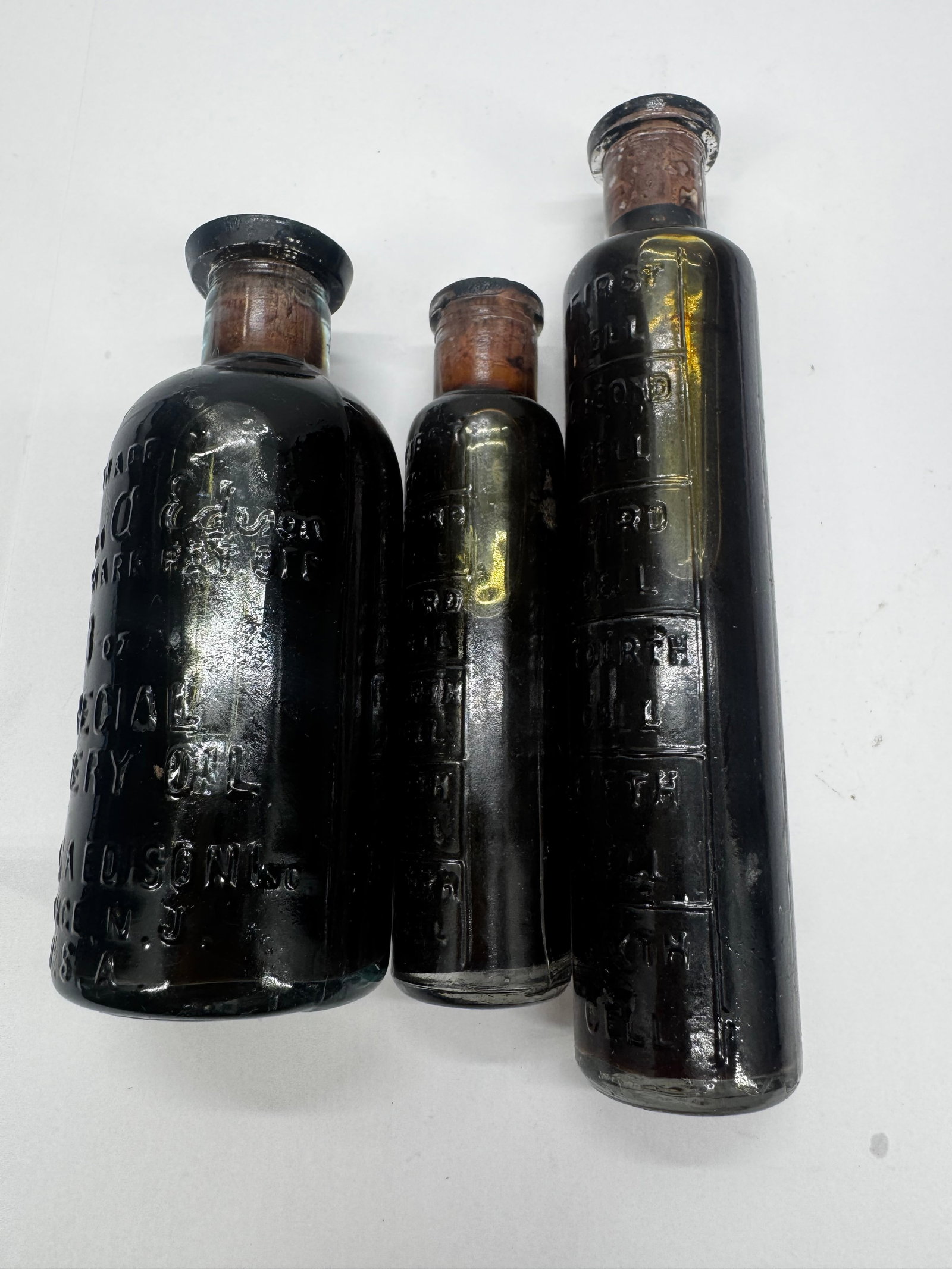 Lot of 3 Antique Thomas A. Edison Special Battery Oil Embossed Glass Bottles: Lot of three antique embossed Thomas A. Edison Special Battery Oil glass bottles in assorted sizes, including a desirable 6 oz. example. Embossed Thomas A. Edison, Trade Mark, and Special Battery Oil,