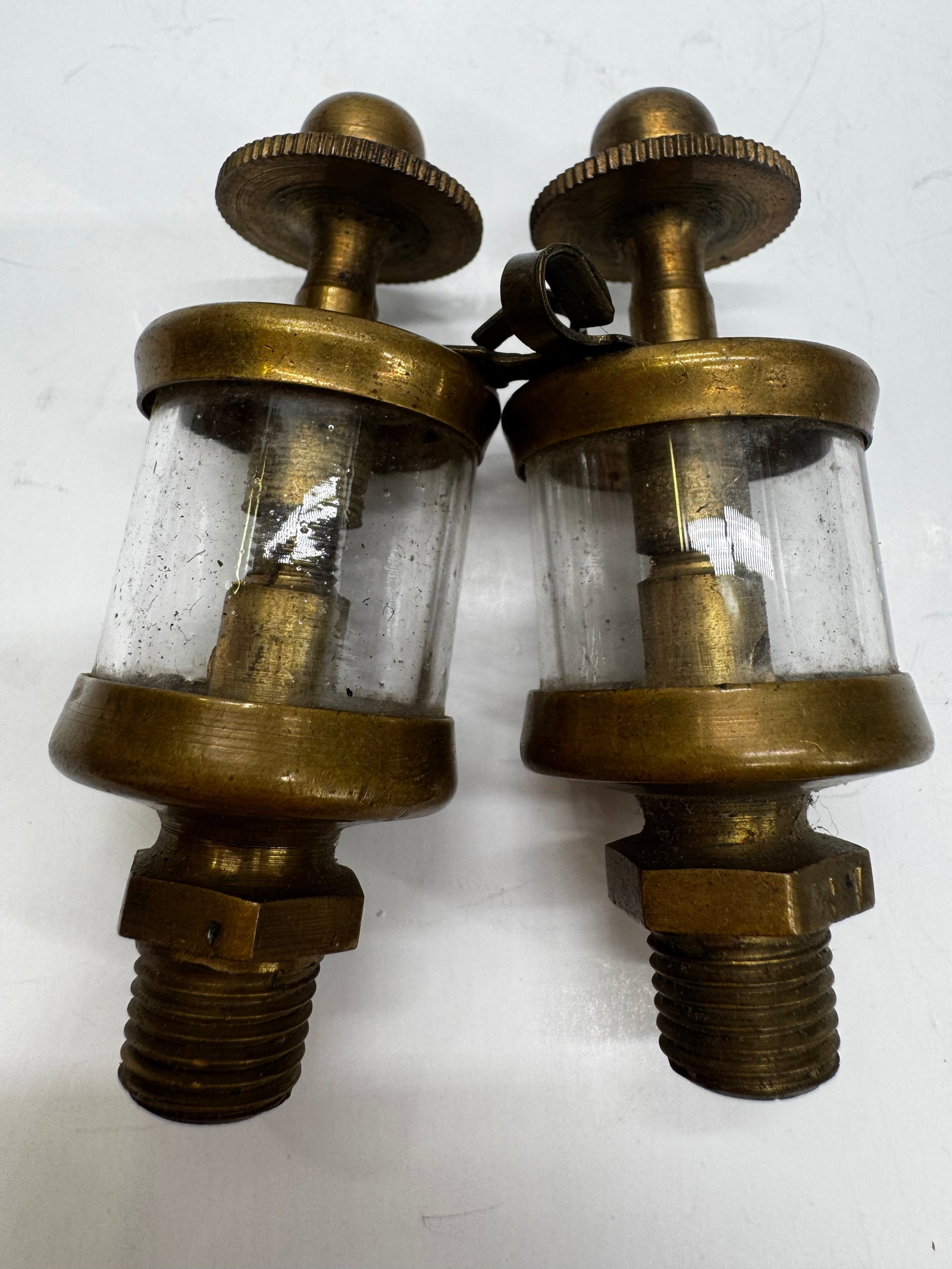 Antique Detroit Lubricator Co. Brass Mechanical Drip Oilers Pair: Matched pair of antique brass and glass mechanical drip lubricators manufactured by The Detroit Lubricator Co., Detroit, Michigan. These oilers were used on steam engines, stationary engines, and othe