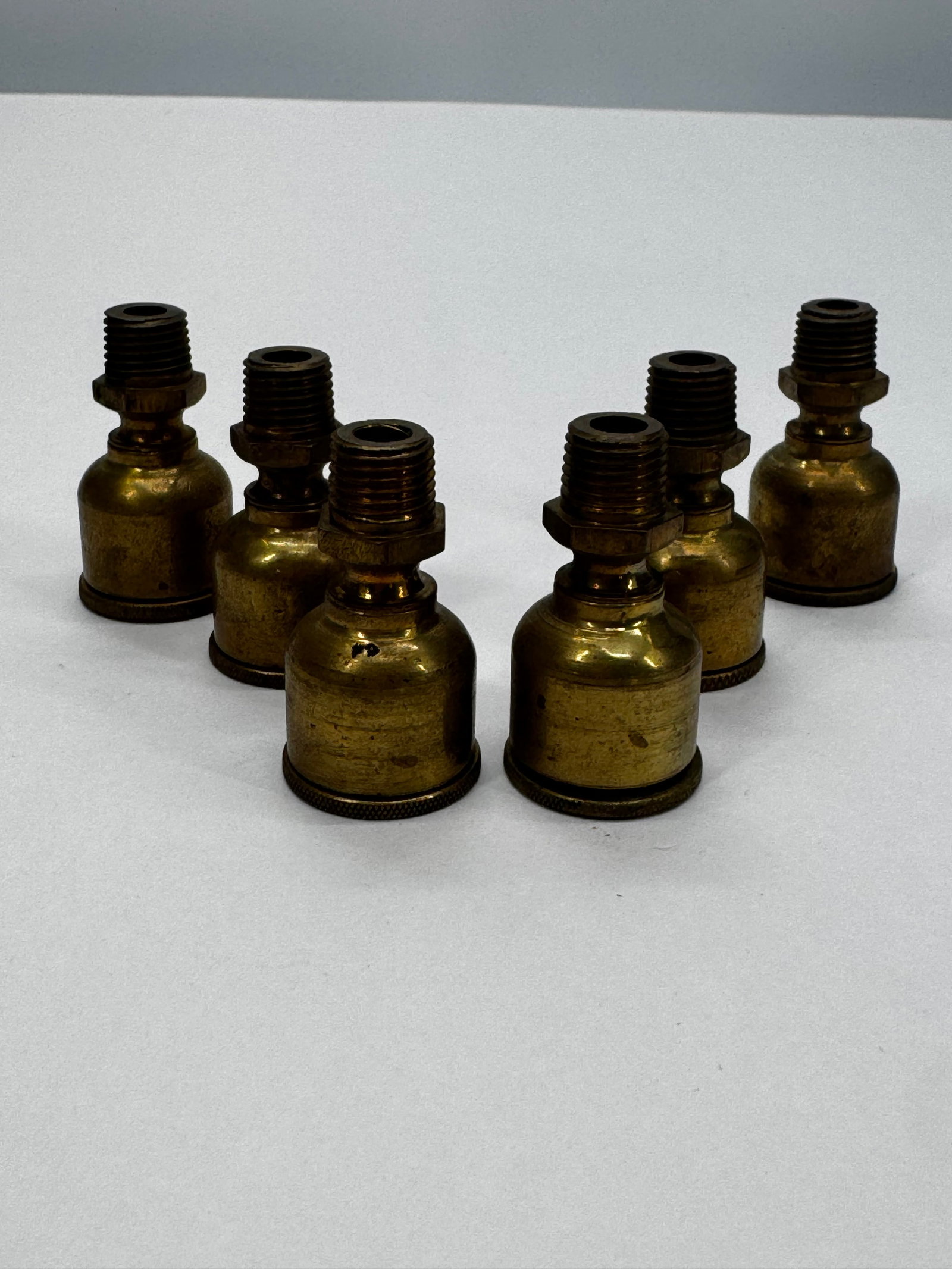 Lot of 6 Antique Lunkenheimer Brass Oiler Bases Steam Engine Parts: Lot of six original antique brass oiler bases by Lunkenheimer Co., Cincinnati, Ohio. These are incomplete oil cups/lubricators, consisting of the threaded brass bases only. Ideal for restoring antique