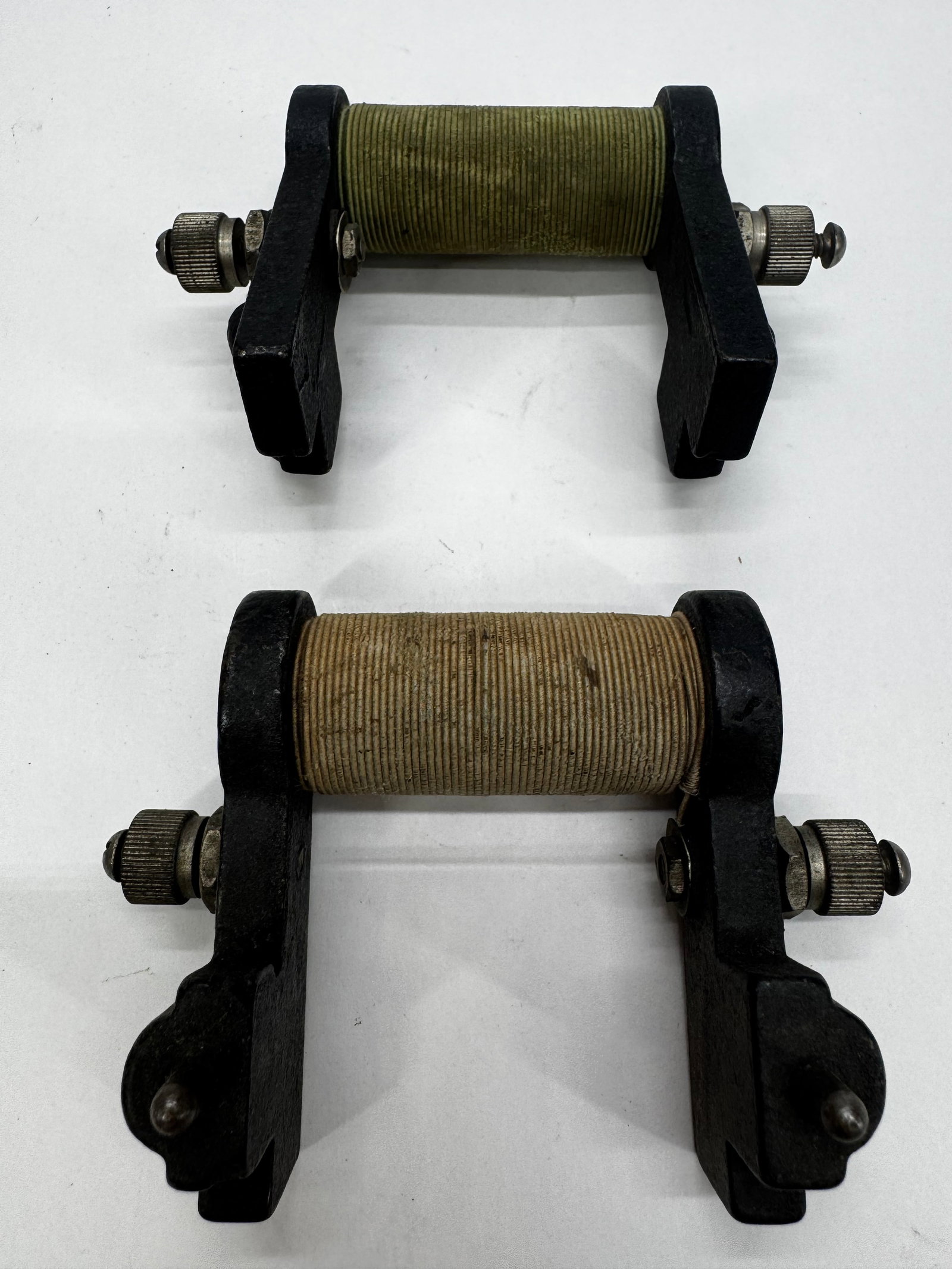 Antique Wire-Wound Rheostats Variable Resistors Pair: Pair of antique wire-wound rheostats with cast iron frames, ceramic resistance coils, and nickel-plated adjustment terminals. These early variable resistors were used to regulate current in laboratory