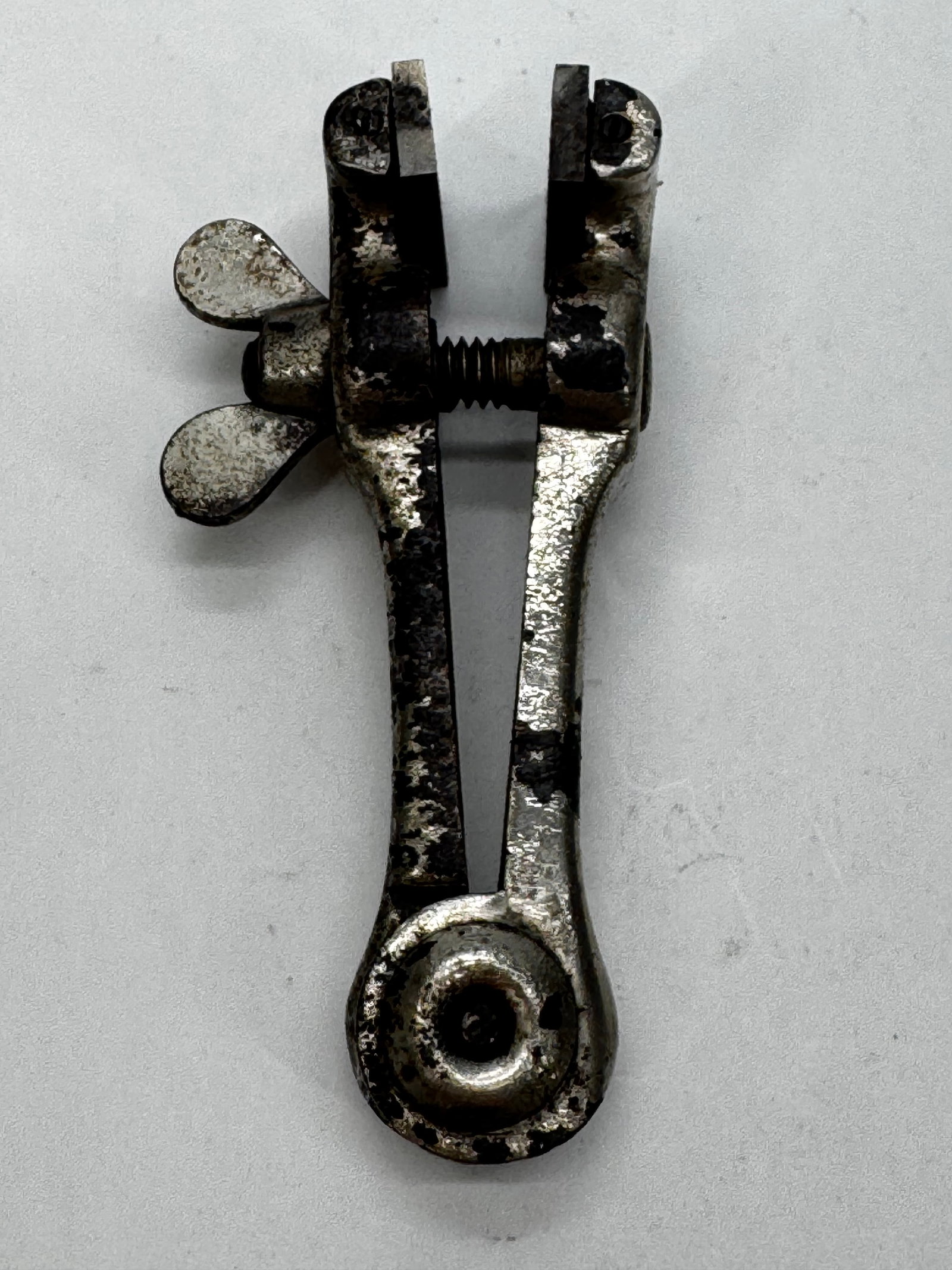 Vintage Cast Steel Hand Vise Broad Arrow 1948: Vintage cast steel spring-loaded hand vise marked with the British Broad Arrow military acceptance mark and dated 1948. Features adjustable jaws with a wing-nut screw for securely holding small parts 