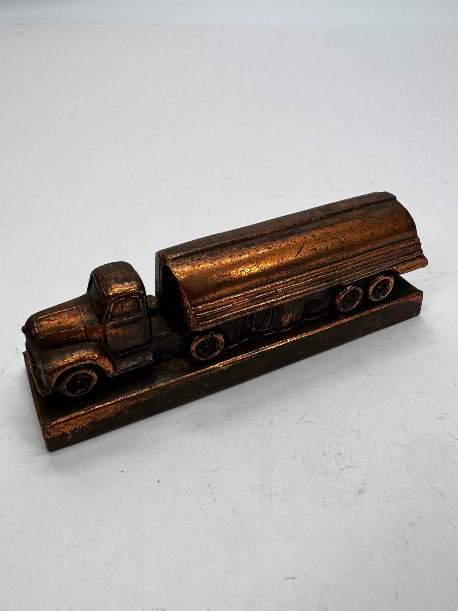 Vintage Banthrico Better Buy Bowzer Tanker Truck Paperweight: Vintage 1950s Banthrico cast metal “Better Buy Bowzer’s” tanker truck paperweight. Features a bronze/copper-tone finish with detailed truck casting and advertising lettering. Produced as a p