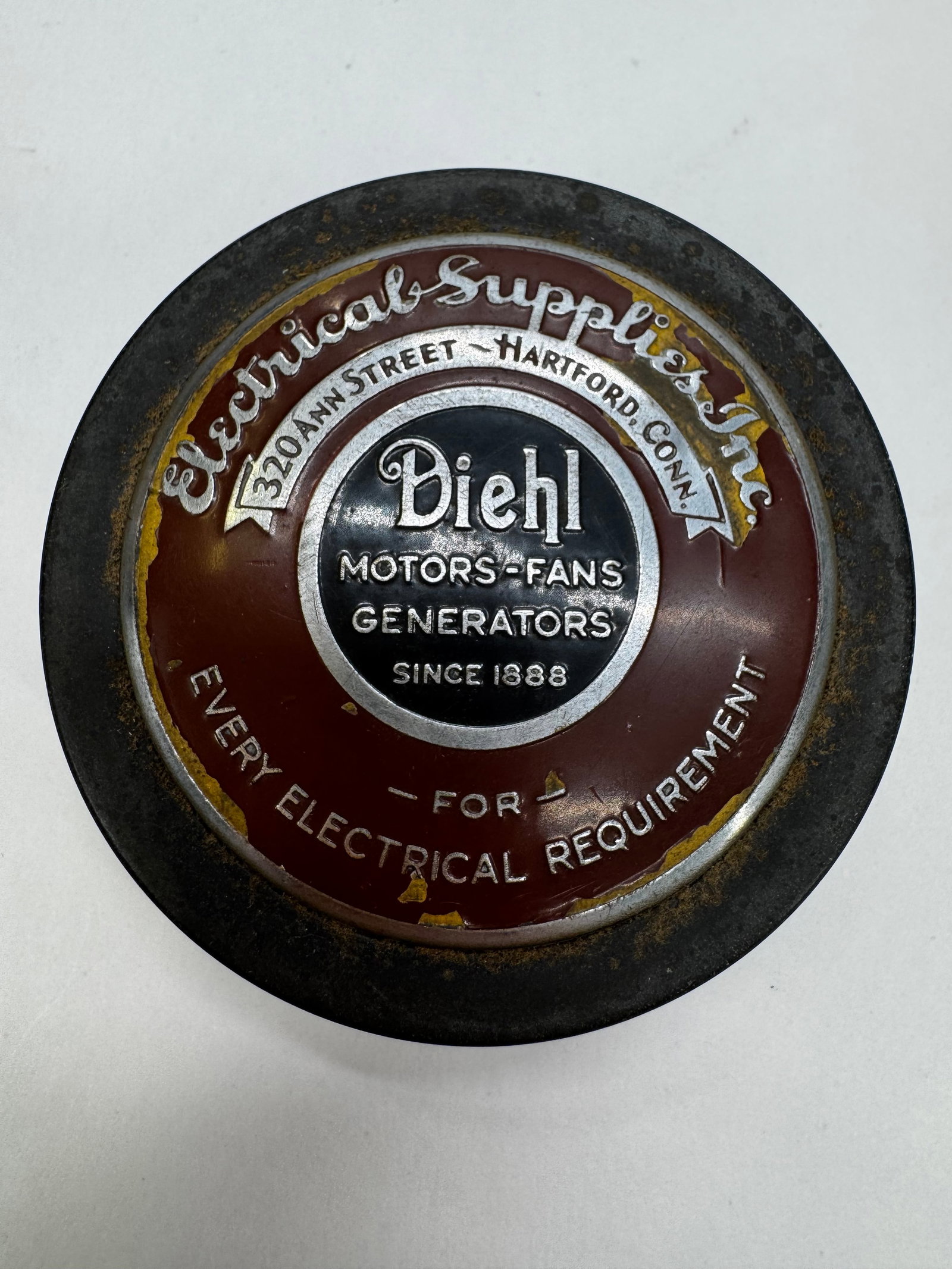 Vintage Diehl Electrical Supplies Advertising Bakelite Paperweight: Vintage Diehl Motors, Fans & Generators advertising paperweight featuring Electrical Supplies, Inc., 320 Ann Street, Hartford, Connecticut. Constructed in a heavy Bakelite-style puck with a colorful e