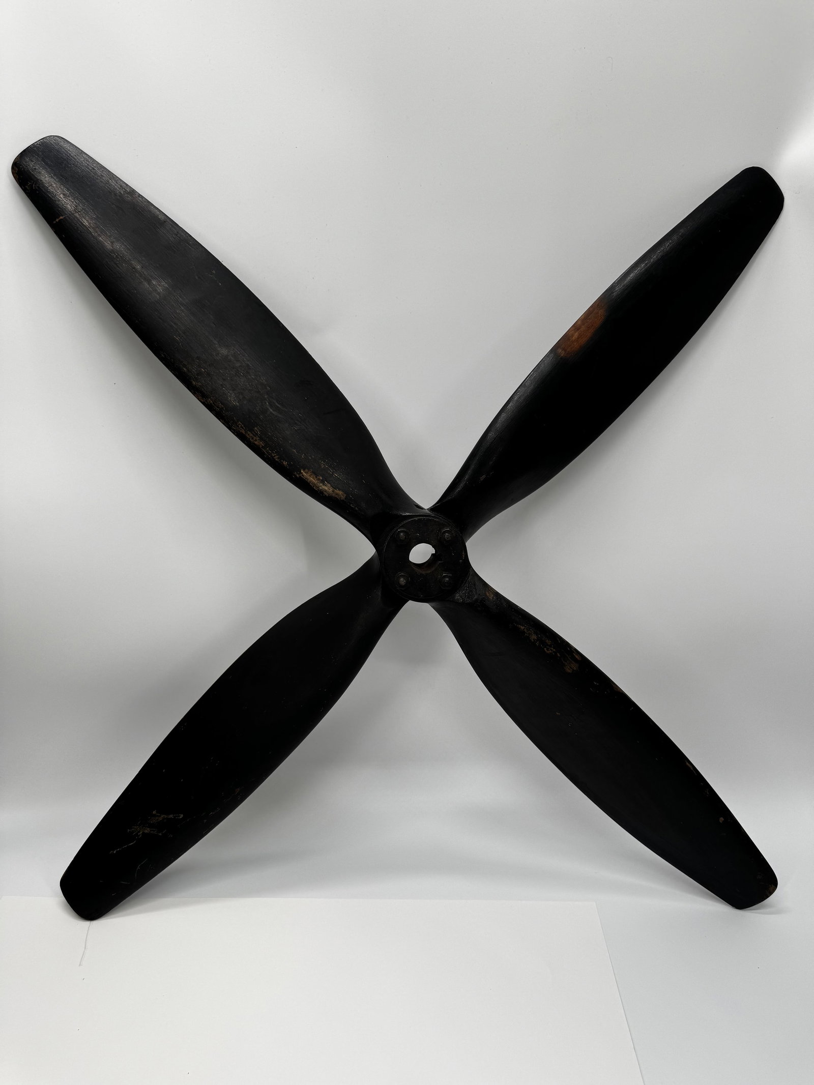 Antique 32” Wooden 4-Blade Industrial Fan Propeller: Large antique 4-blade wooden industrial fan propeller, approximately 32 inches in diameter with a keyed 1-inch center bore. Black-painted hardwood blades attached to a steel hub with four bolts. Likel