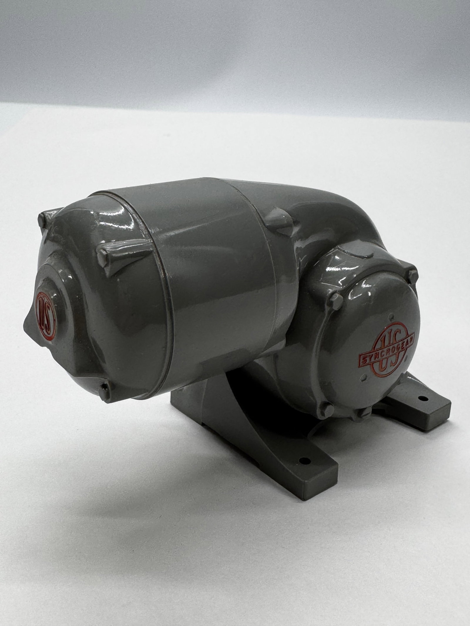 Vintage US Syncrogear Gear Reducer Salesman Sample Model: Vintage US Syncrogear gear reducer salesman sample or display model manufactured by Ideal Models, Detroit. Features a gray painted cast-metal body with raised red Syncrogear logo and mounting base. Pr