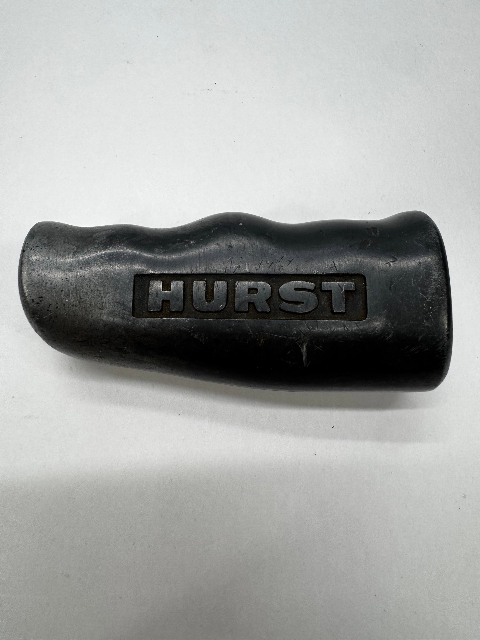Aluminum T-Handle Shifter Knob 3/8-16: Vintage Hurst T-handle manual shifter knob with a black anodized aluminum finish and embossed HURST logo. Designed with an ergonomic grip for comfortable shifting in classic muscle cars, hot rods, and