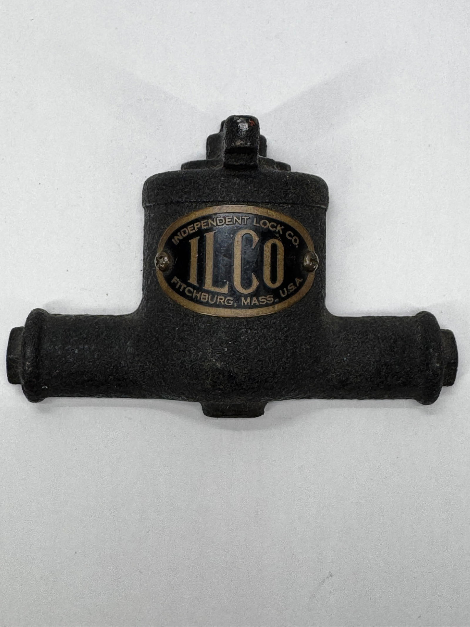 Vintage ILCO Independent Lock Co. Cast Iron Paperweight: Vintage ILCO (Independent Lock Co.) cast iron paperweight featuring the classic ILCO oval logo and “Fitchburg, Mass., U.S.A.” lettering. Finished in textured black with a green felt bottom to 