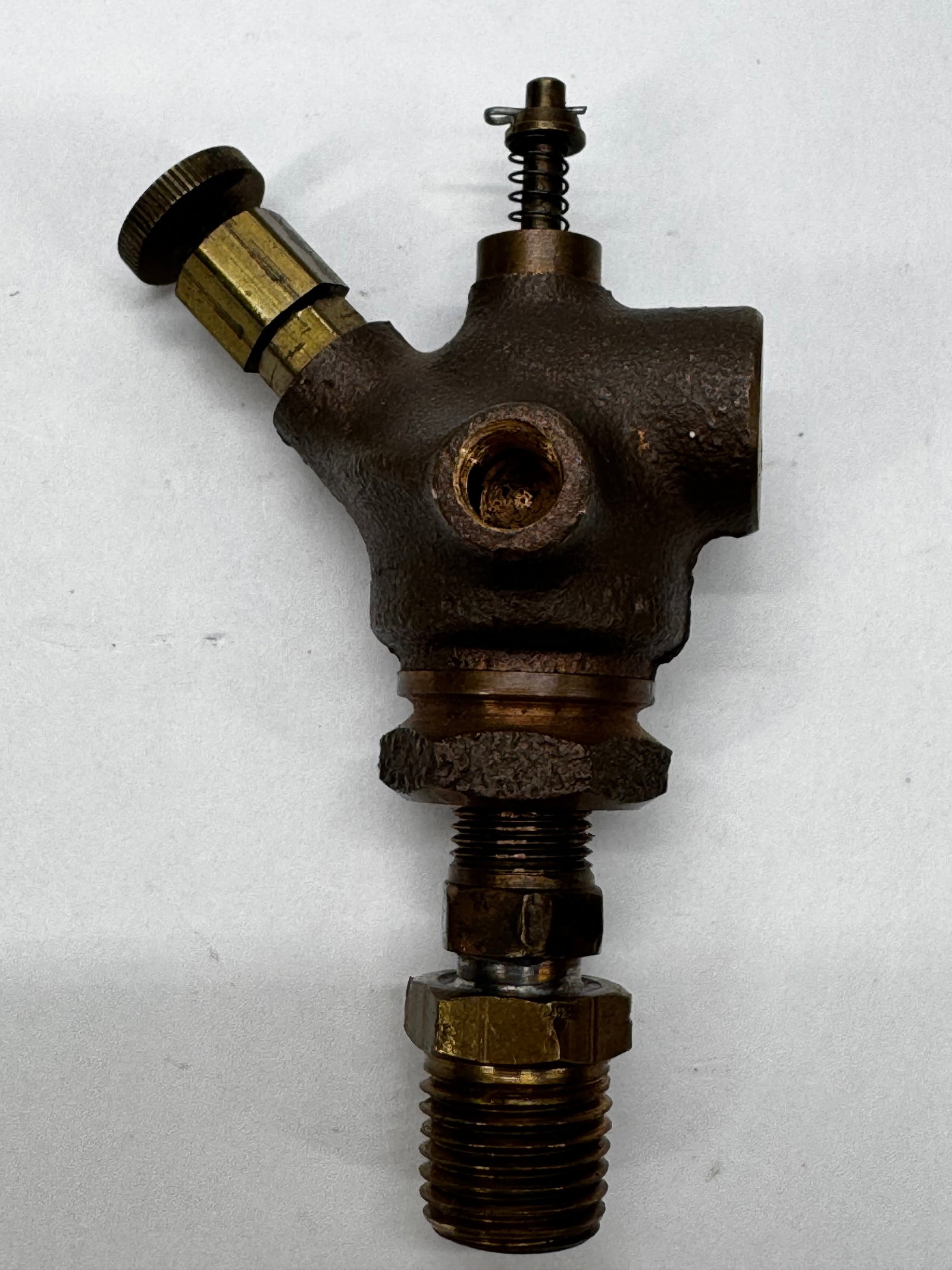 Vintage Bronze Steam Engine Oiler Lubricator Valve: Vintage bronze steam engine lubricator or mechanical oiler valve featuring a heavy cast body with brass adjustment screw, spring-loaded plunger, and threaded pipe connections. Designed to regulate the