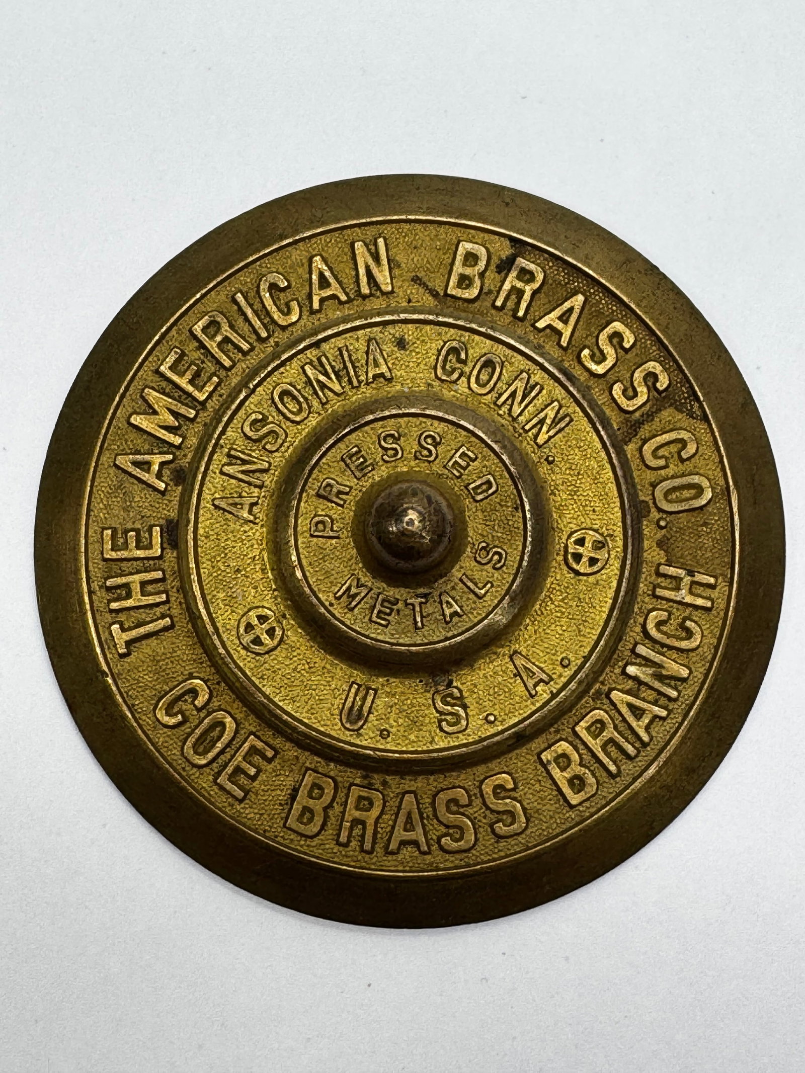 Antique American Brass Co. Pressed Brass Paperweight: Antique solid brass advertising paperweight for The American Brass Co., Ansonia, Conn., U.S.A. The raised lettering includes the slogan “Pressed Metals” and “Brass Branch,” making it a