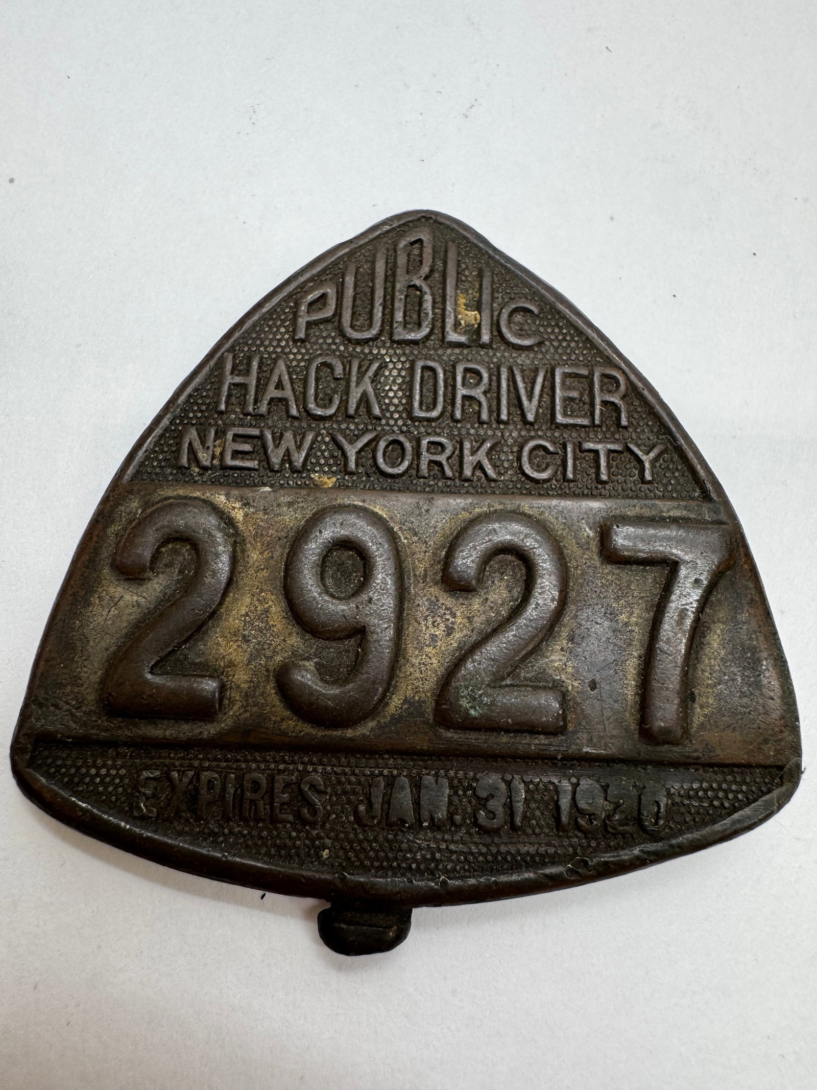 1930 NYC Public Hack Driver Badge #2927 Taxi License: Original 1930 New York City Public Hack Driver license badge, numbered 2927, with “Expires Jan. 31, 1930” cast on the front. Heavy cast brass/bronze construction with original mounting clip on