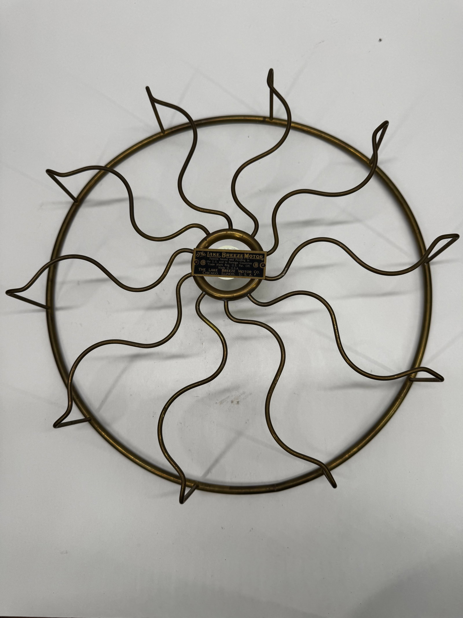 Antique Lake Breeze Motor Co. Fan Brass Cage Guard Chicago: Original antique brass fan cage/guard from a Lake Breeze Motor Co. electric fan, manufactured in Chicago, Illinois, USA, circa 1910–1920. Features the original black and gold Lake Breeze Motor Co. i