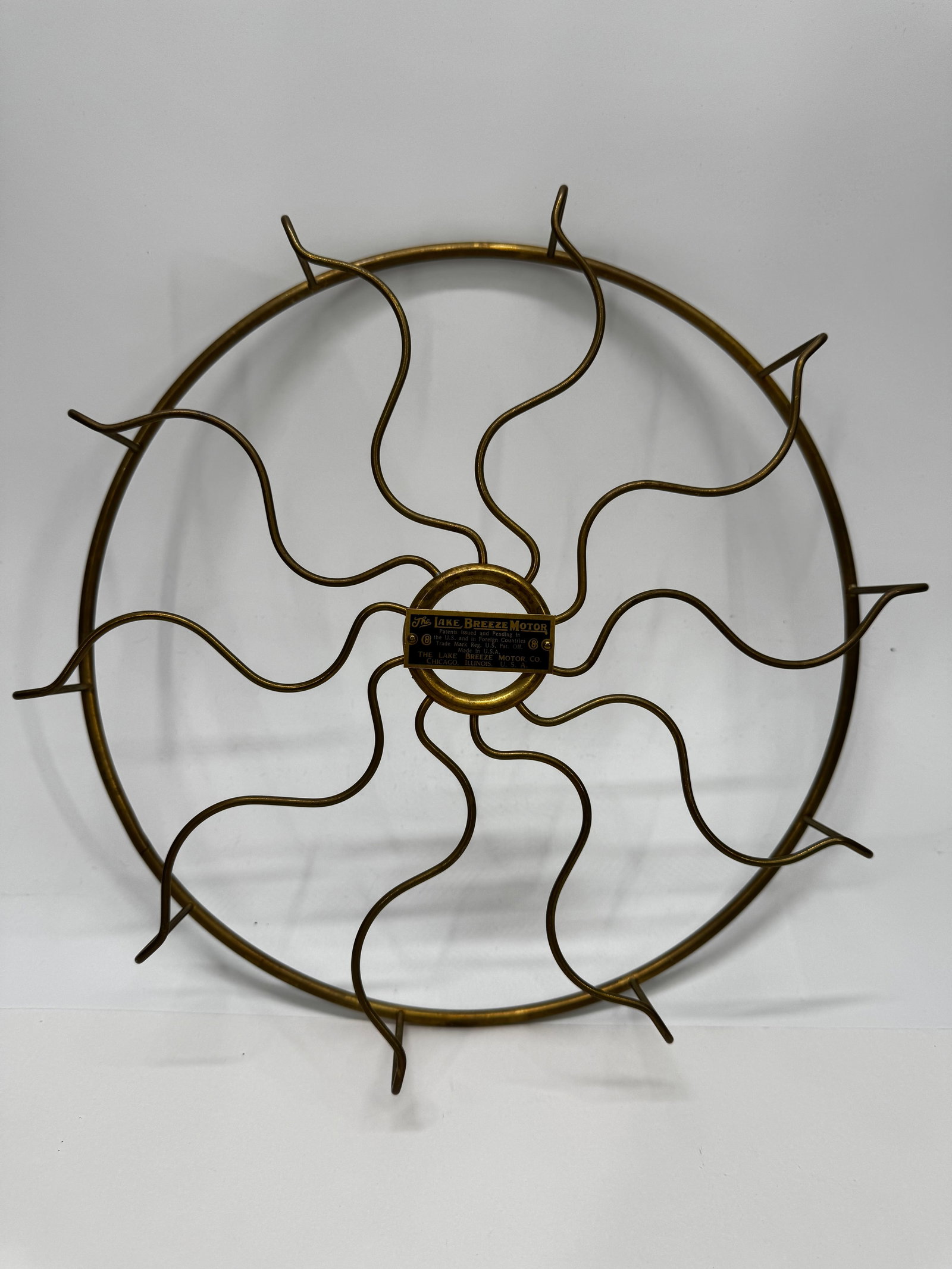 Antique Lake Breeze Motor Co. Brass Fan Cage Guard Chicago IL: Original antique brass front cage/guard from a Lake Breeze Motor Co. electric fan, manufactured in Chicago, Illinois, circa 1910–1920. Features the original black-and-gold “The Lake Breeze Motor&r