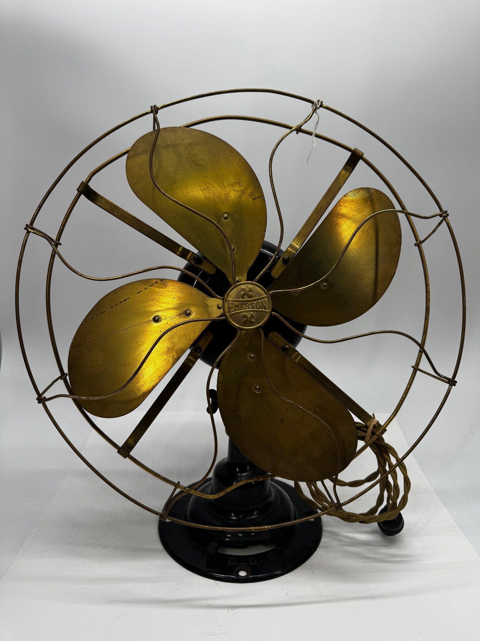 Antique Emerson 16” Brass Blade Desk Fan Type 16646 110V: Antique Emerson Electric Mfg. Co. desk fan featuring a heavy cast iron base, four brass blades, and original Emerson center badge. Motor tag is marked Type 16646, 110 Volts, 60 Cycles, and 108 Watts. 