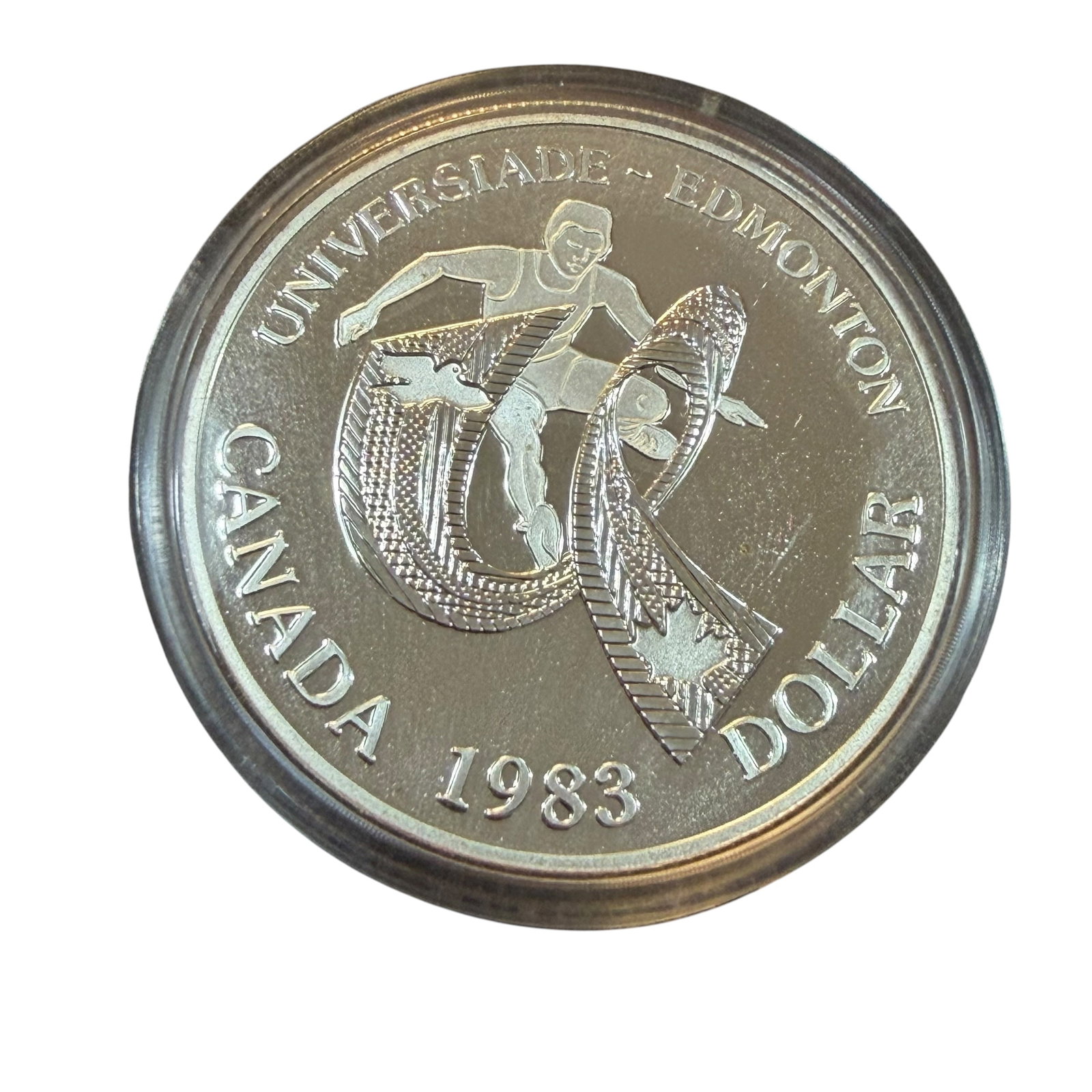 1983 University Games Canada Dollar Silver Coin & Case Uncirculated 23.33g: Description: Uncirculated coin, Elizabeth II D.G. Regina, Canada Dollar XII World University Games 1983. Sealed in holder and with original display case. / Material: .5000 Silver. 36.07 mm dia. 23.33 