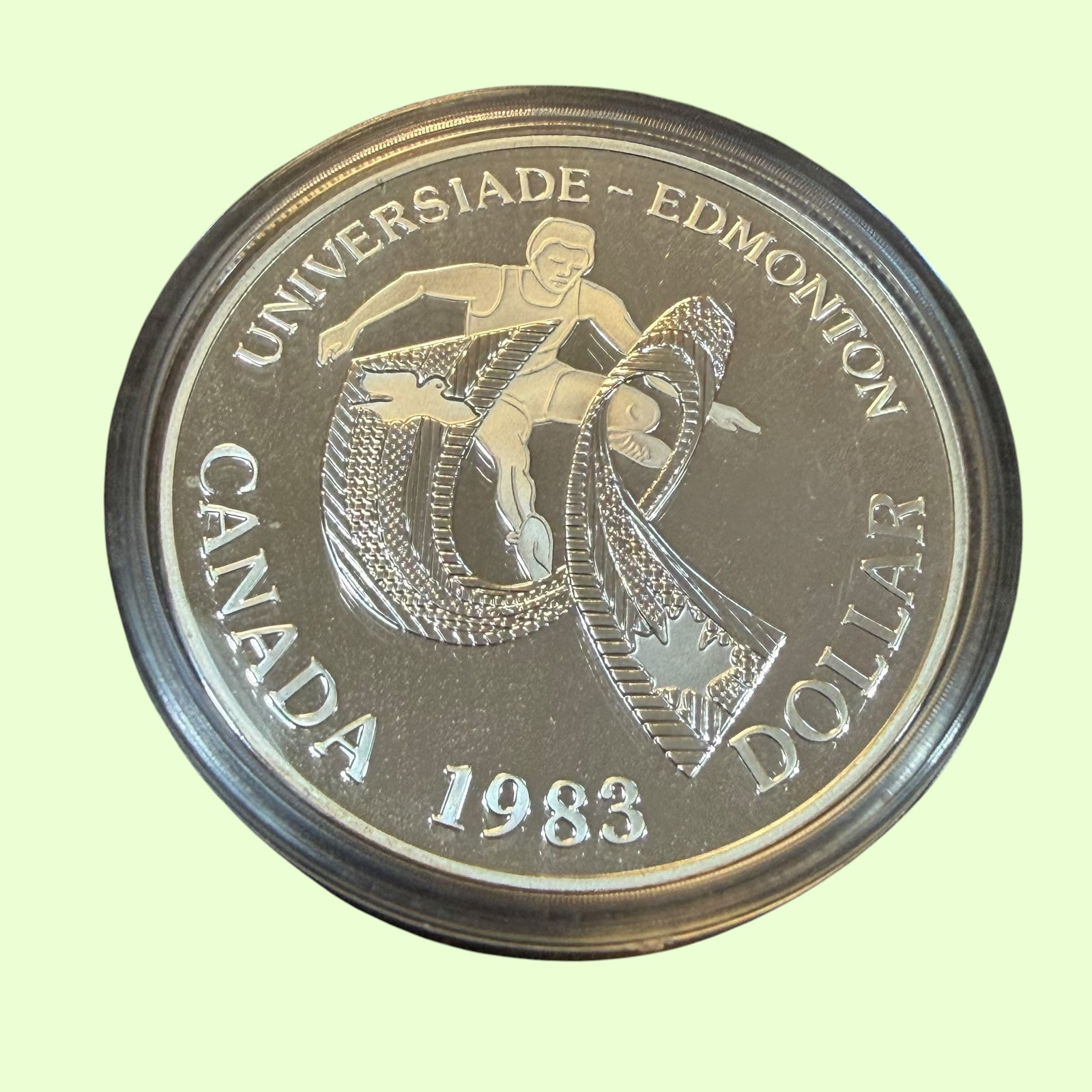 University Games 1983 Canada Dollar Silver Coin & Case Uncirculated 23.33g: Description: Uncirculated coin, Elizabeth II D.G. Regina, Canada Dollar World University Games 1983. Sealed in holder and with original display case. / Material: .5000 Silver. 36.07 mm dia. 23.33 gram