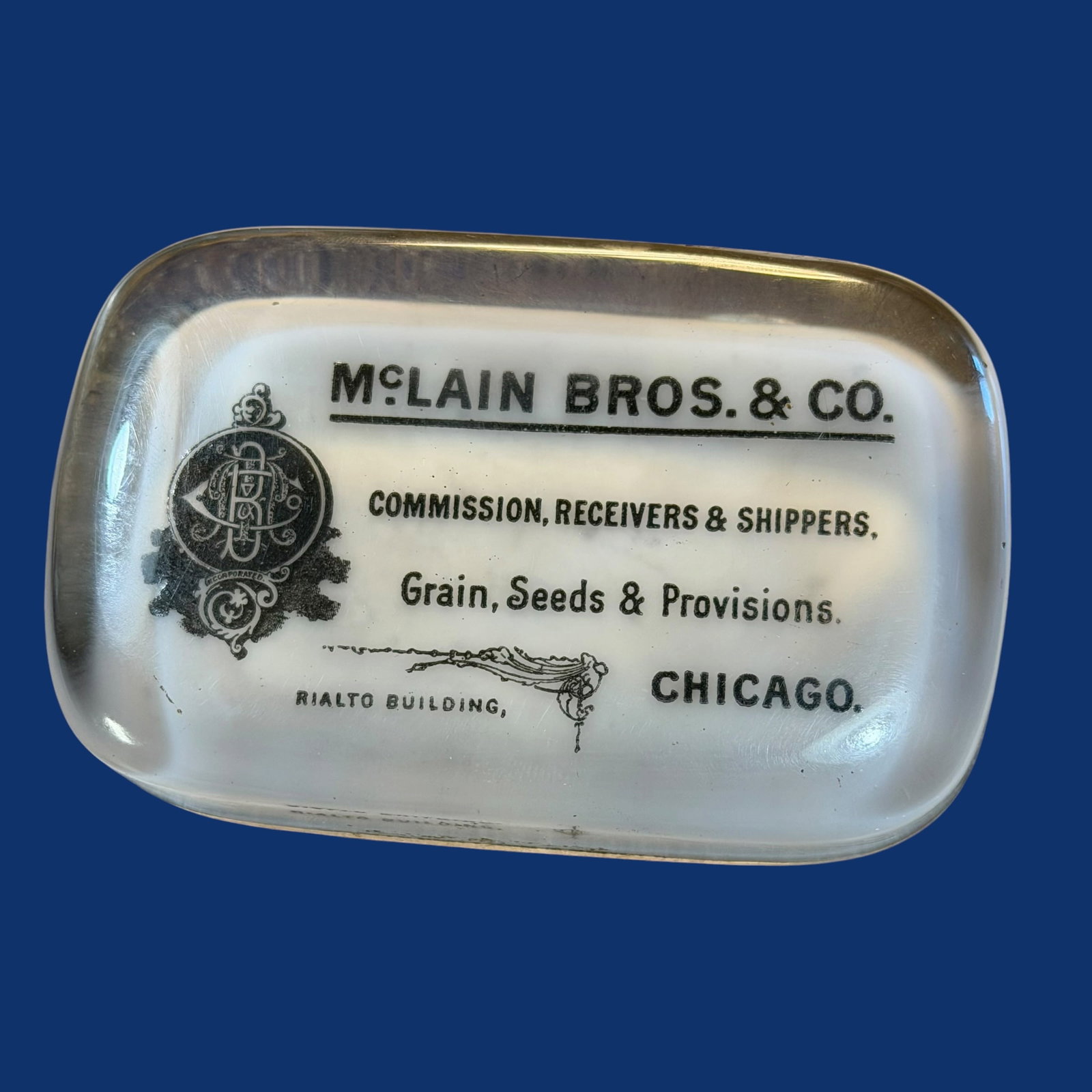 Antique Glass Paperweight Advertising McLain Bros Chicago Grain Seed Provisions Farming: Description: Glass paperweight from the early 1900s. Advertising McLain Bros & Co. Commission, Receivers & Shippers. Grain, Seeds and Provisions. Chicago (Illinois). Rialto Building. / Material: Glass