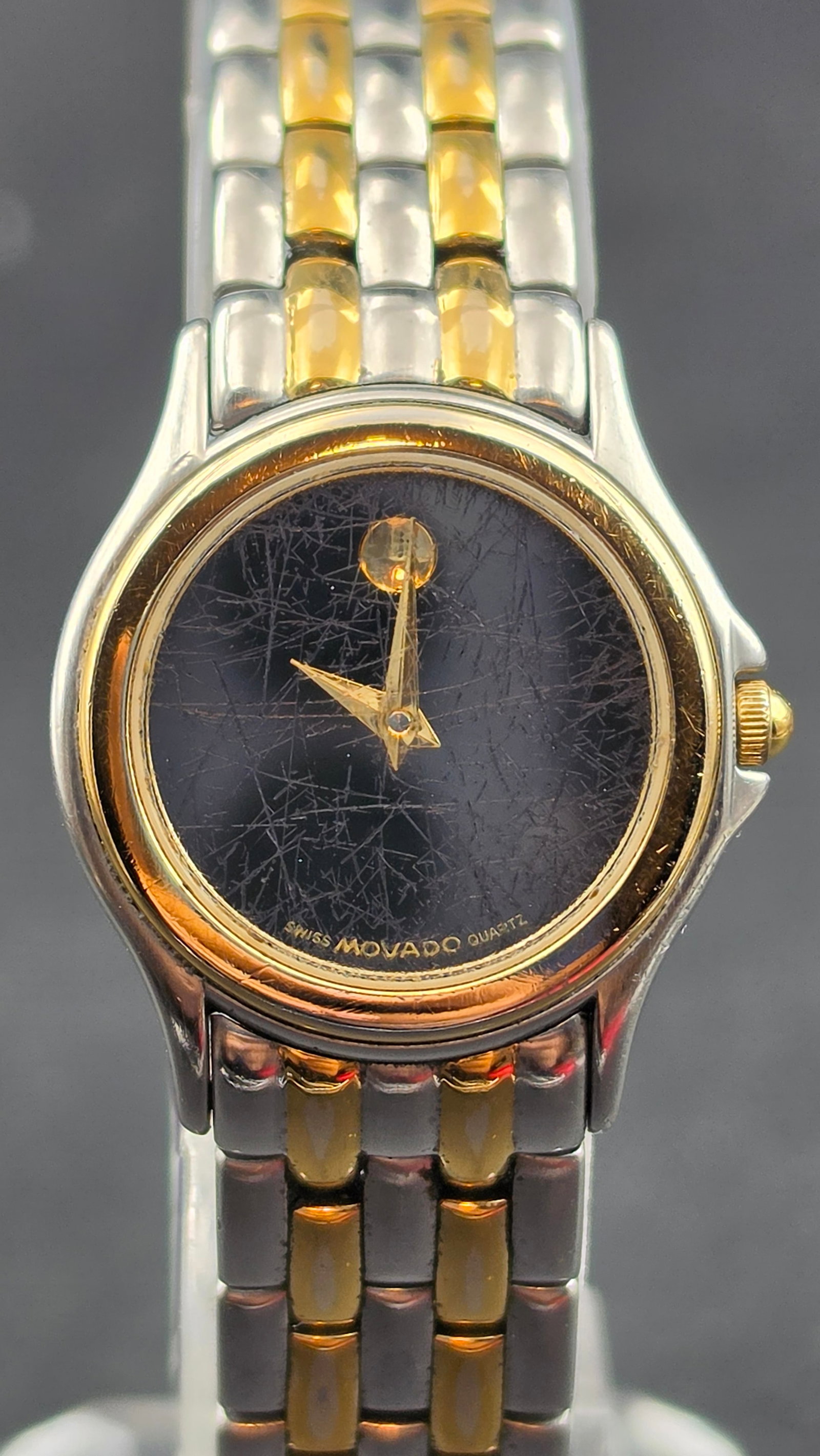 Vintage 1990s Movado Museum Ladies Quartz Watch Ref 81-E4-9812 Two-Tone Black Dial 24mm: This is a Movado Museum ladies quartz wristwatch, reference 81-E4-9812, confirmed by the case back stampings "Movado Since 1881, Water Resistant, All Stainless Steel, Quartz." The signature Museum dia
