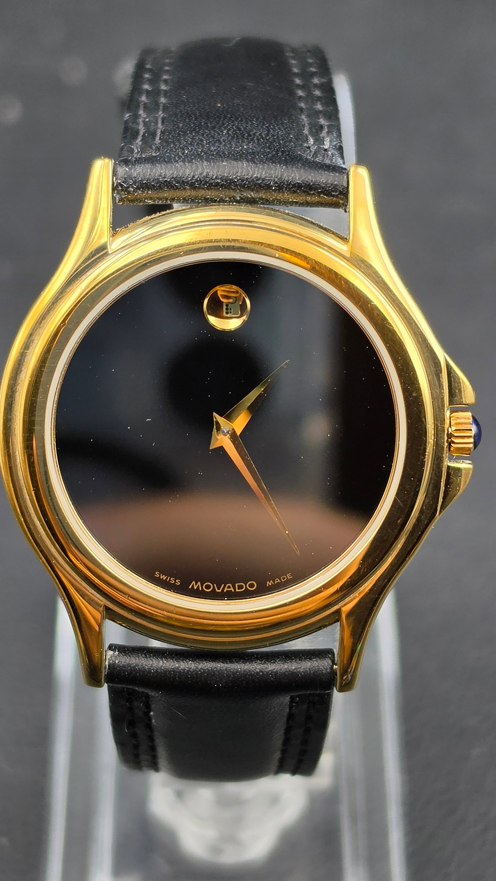 Movado Museum Classic Swiss Quartz Watch 87 E4 0863 Gold Tone Black Dial Sapphire Crystal Original S: This is a Movado Museum Classic quartz watch, reference 87 E4 0863, featuring the iconic Museum dial configuration designed by Nathan George Horwitt — a jet-black mirror dial with a single gold dot 