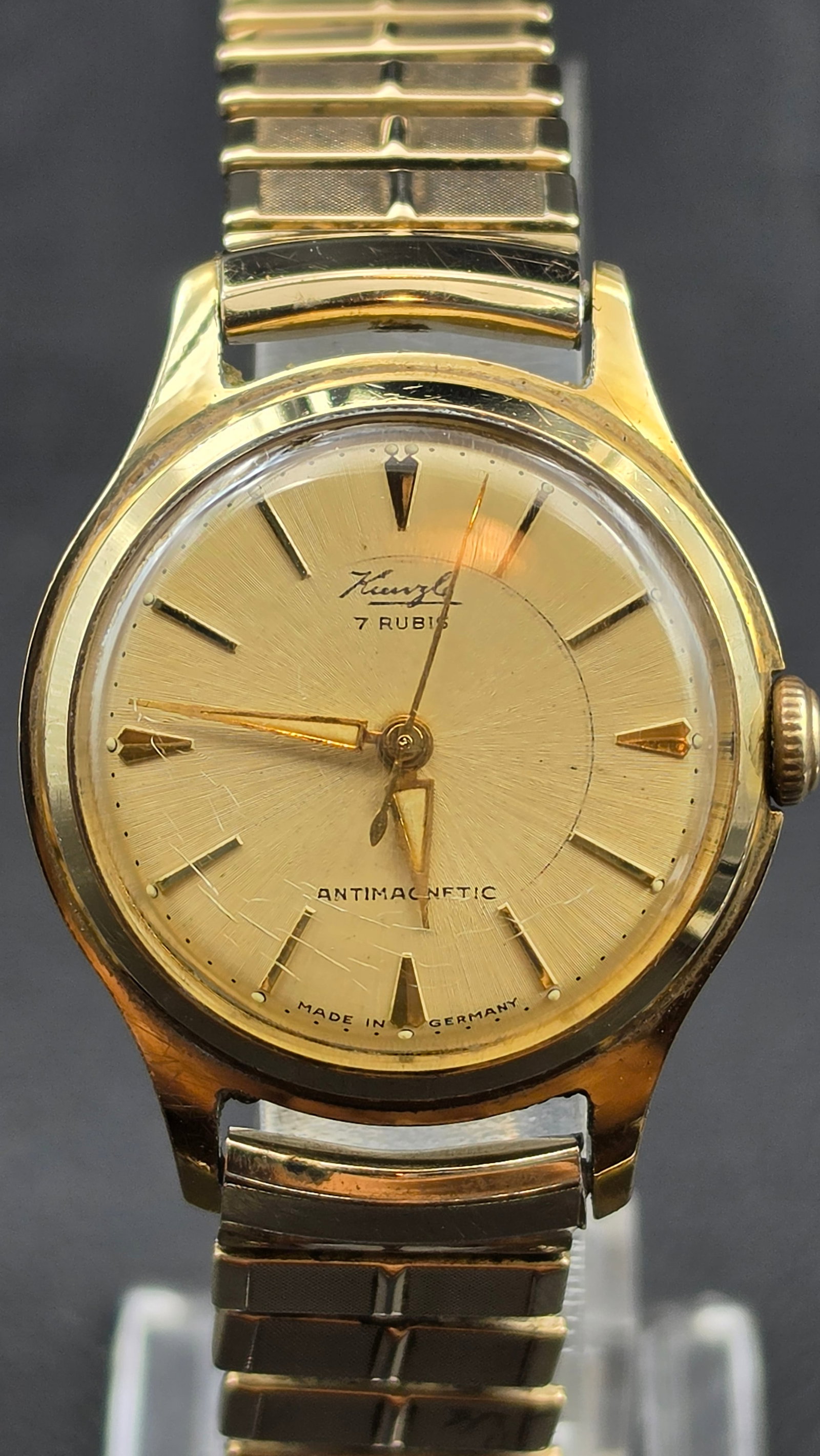 Vintage Kienzle 7 Rubis Antimagnetic Wristwatch Made in Germany 1950s Gold Tone: This is a 1950s Kienzle 7 Rubis Antimagnetic dress wristwatch from Germany's oldest watchmaker (founded 1822), featuring a gold-tone case with a starburst-textured dial, applied dagger markers, and a 