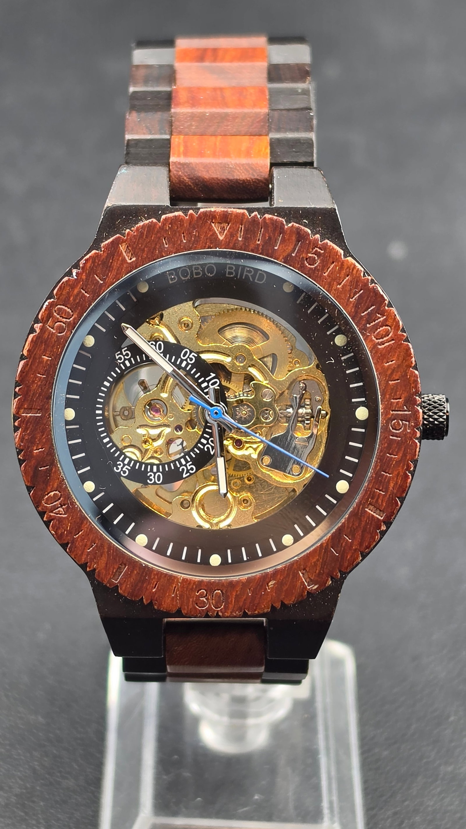 BOBO BIRD Mens Wooden Watch Skeleton Automatic Two Tone Wood Mechanical: This is a BOBO BIRD men's wooden skeleton automatic watch featuring a two-tone ebony and red sandalwood case and matching wood link bracelet. The dial exposes the gold-tone mechanical movement with a 