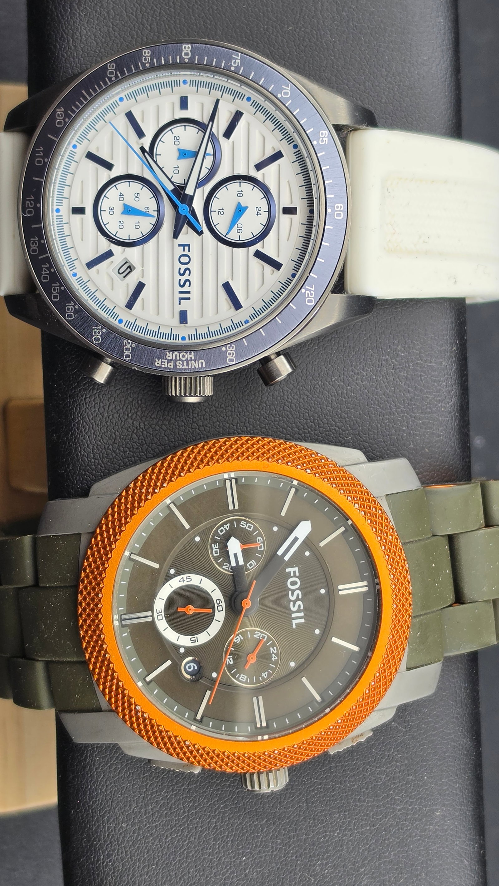 Lot of Two Fossil Multifunction Watches Olive/Orange and White/Navy Chronograph Style: This lot includes two men's Fossil watches with multi-dial chronograph-style layouts, sold together as a group.Watch 1 – Fossil FS-4630A round stainless steel case with an olive-green dial, orange s