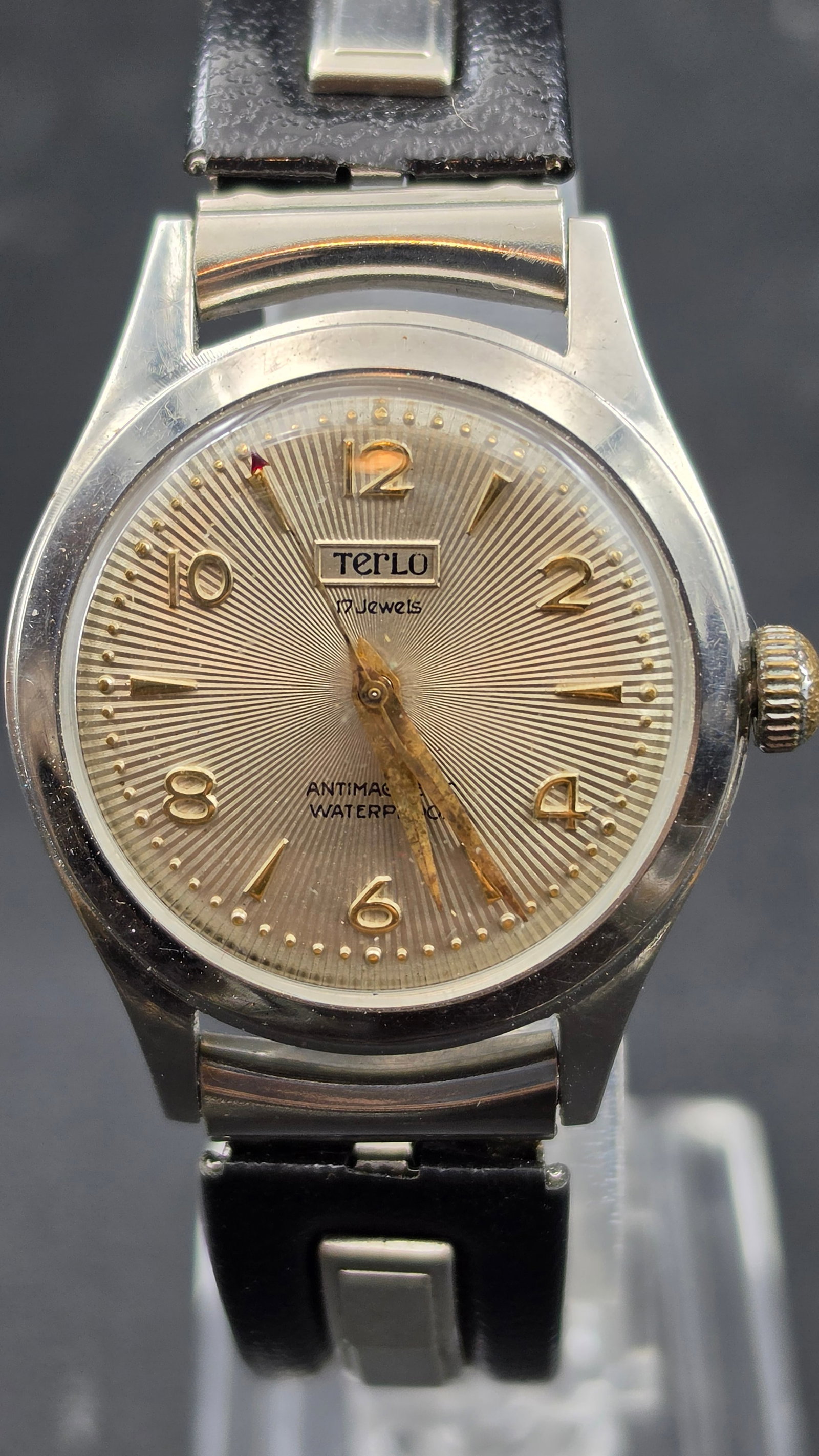 Vintage "Terlo" 17 Jewels Manual Wind Wristwatch, Stainless Steel: A vintage manual-wind wristwatch signed "Terlo," 17 jewels, stainless steel case marked "Antimagnetic" and "Waterproof." Sunburst silver dial with applied gold-tone Arabic numerals and dauphine hands.