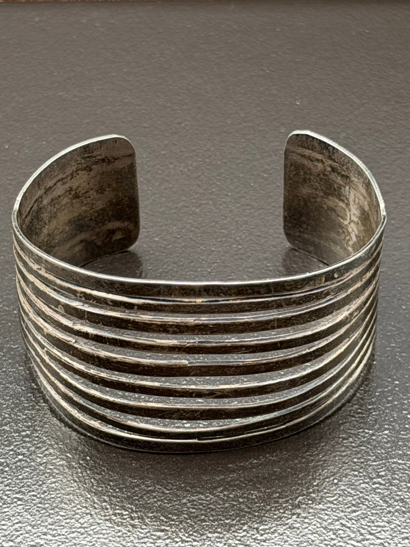 31g-Vintage Sterling Silver Wide Cuff Bracelet Ribbed Modernist Southwestern: Vintage sterling silver wide cuff bracelet featuring a bold ribbed design with multiple parallel bands across the front. Clean lines and substantial construction give this piece a modernist Southweste