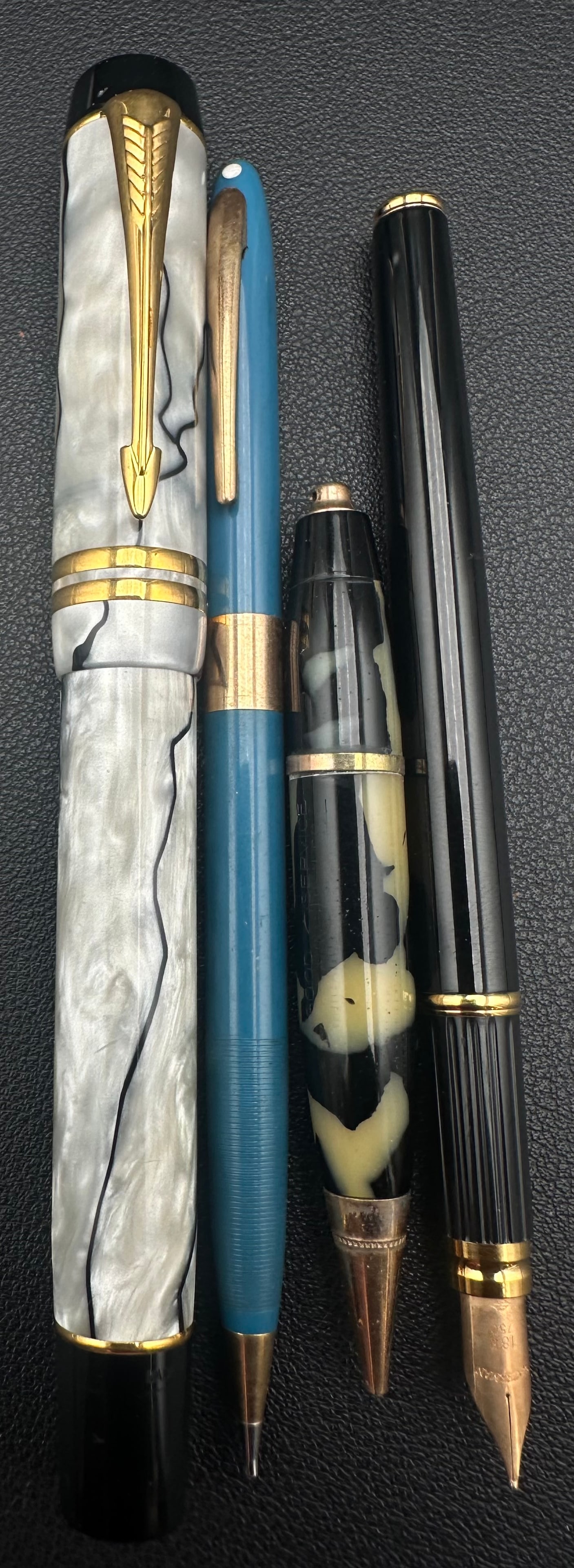 Vintage Waterman 18K Fountain Pen & Assorted Pen Lot of 4: Lot of four vintage writing instruments including a black Waterman fountain pen with an 18K (750) gold nib, a large gray pearlized fountain pen with gold-tone trim, one blue mechanical pencil, and one