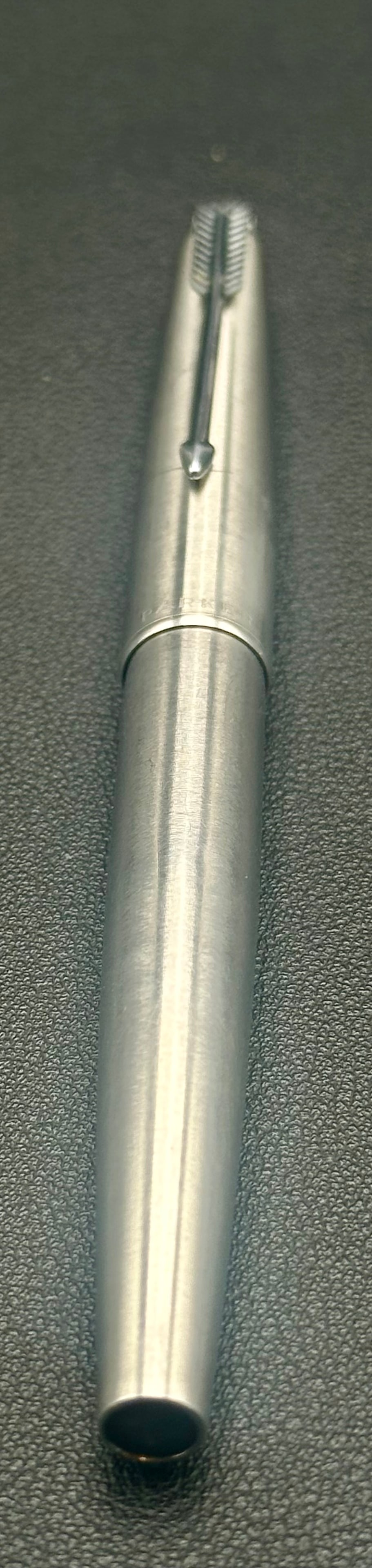 Vintage Parker 61 Flighter Stainless Steel Fountain Pen: Vintage Parker 61 Flighter fountain pen with a brushed stainless steel cap, black resin barrel and grip, and the iconic Parker arrow clip with hooded nib. Made in England, circa 1960s–1970s. Pre-own