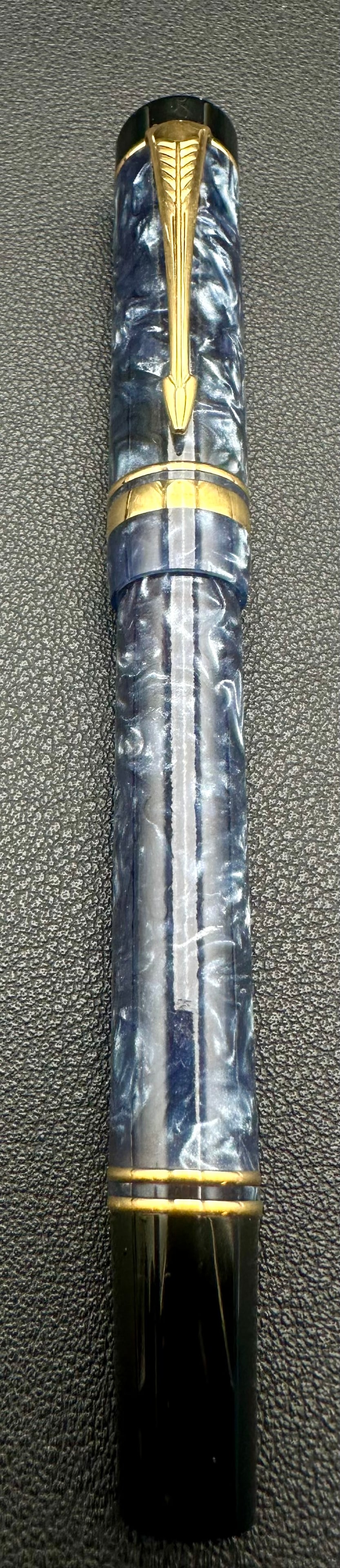 Parker Duofold International Blue Marble Rollerball Pen Gold Trim: Vintage Parker Duofold International rollerball pen featuring a blue marbled acrylic barrel and cap with gold-plated trim and the iconic Parker arrow clip. A premium writing instrument made in the UK,