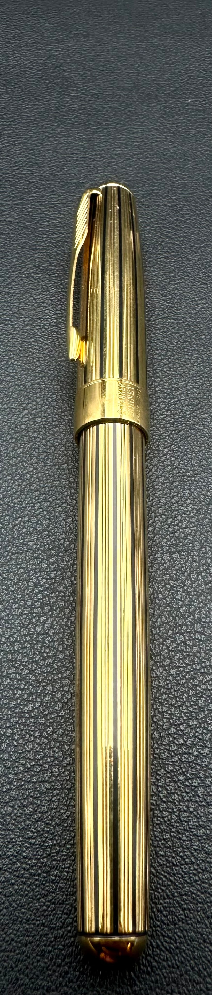 Parker Sonnet Ciselé Gold Plated Ballpoint Pen France 2002: Authentic Parker Sonnet twist ballpoint pen featuring the classic gold-plated Ciselé pinstripe finish with black resin grip and Parker arrow clip. Made in France, with cap band date code IIIL indicat