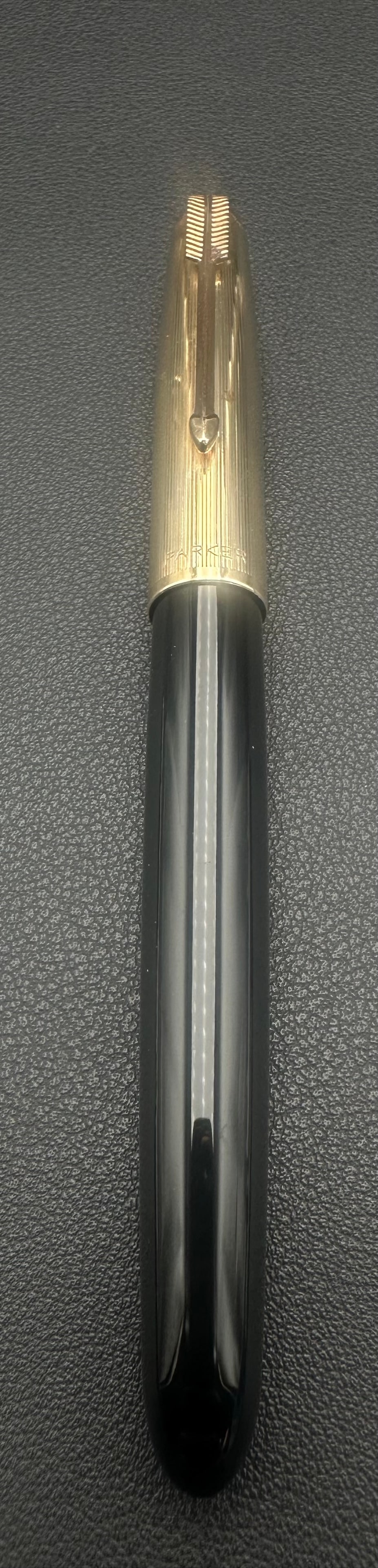 Parker 51 Fountain Pen Black 1/10 14K Gold Filled Cap USA: Vintage Parker 51 fountain pen featuring a black Lucite barrel and a ribbed 1/10 14K gold-filled cap with the iconic Parker arrow clip. Cap is marked “1/10 14K Gold Filled – Made in USA.” On