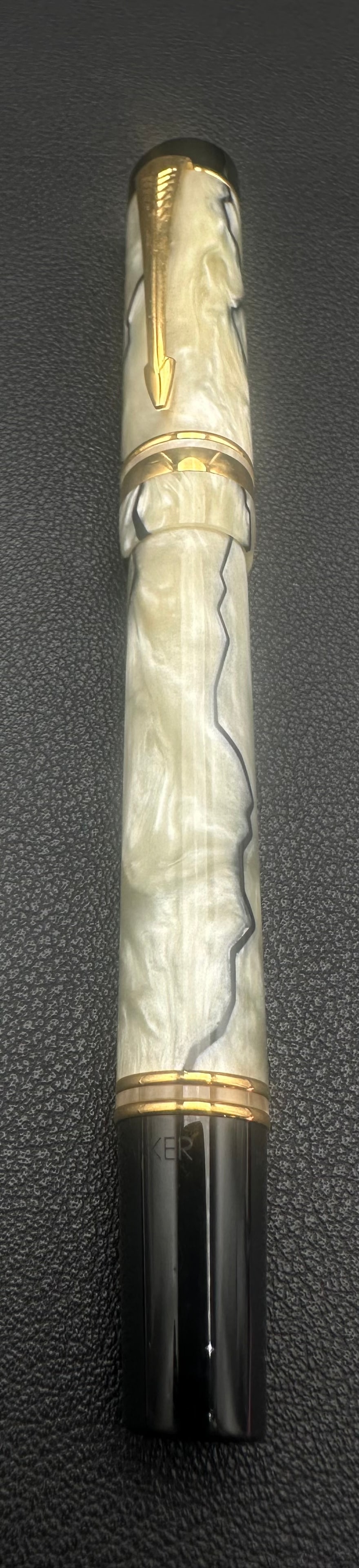 Parker Duofold International Pearl & Black Fountain Pen 18K Gold Nib: Elegant Parker Duofold International fountain pen featuring the sought-after Pearl & Black marbled acrylic finish with black accents and gold-plated trim. Fitted with an 18K (750) gold nib and include