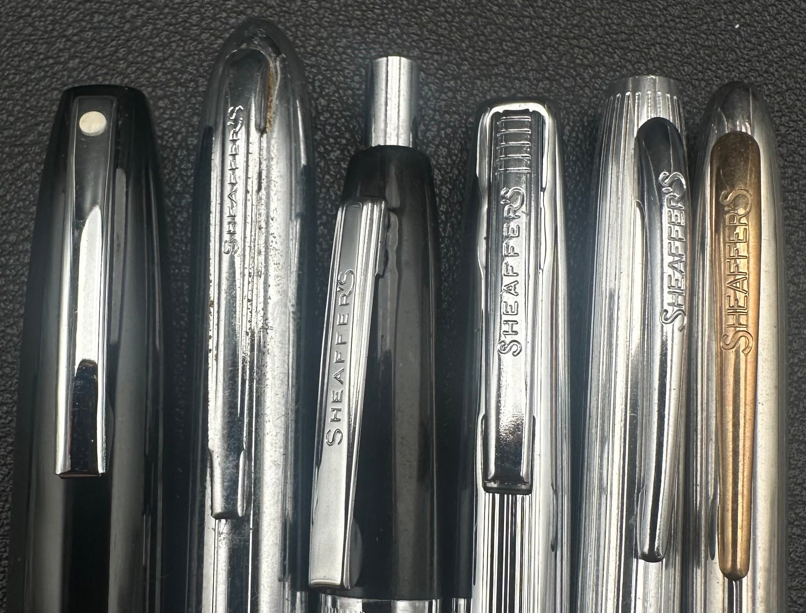 Vintage Sheaffer Pen & Pencil Lot of 6 Including Sentinel USA: Lot of six vintage Sheaffer writing instruments, including a mix of fountain pens, ballpoint pens, and mechanical pencils. Features black and stainless steel finishes, including a Sheaffer Sentinel-st