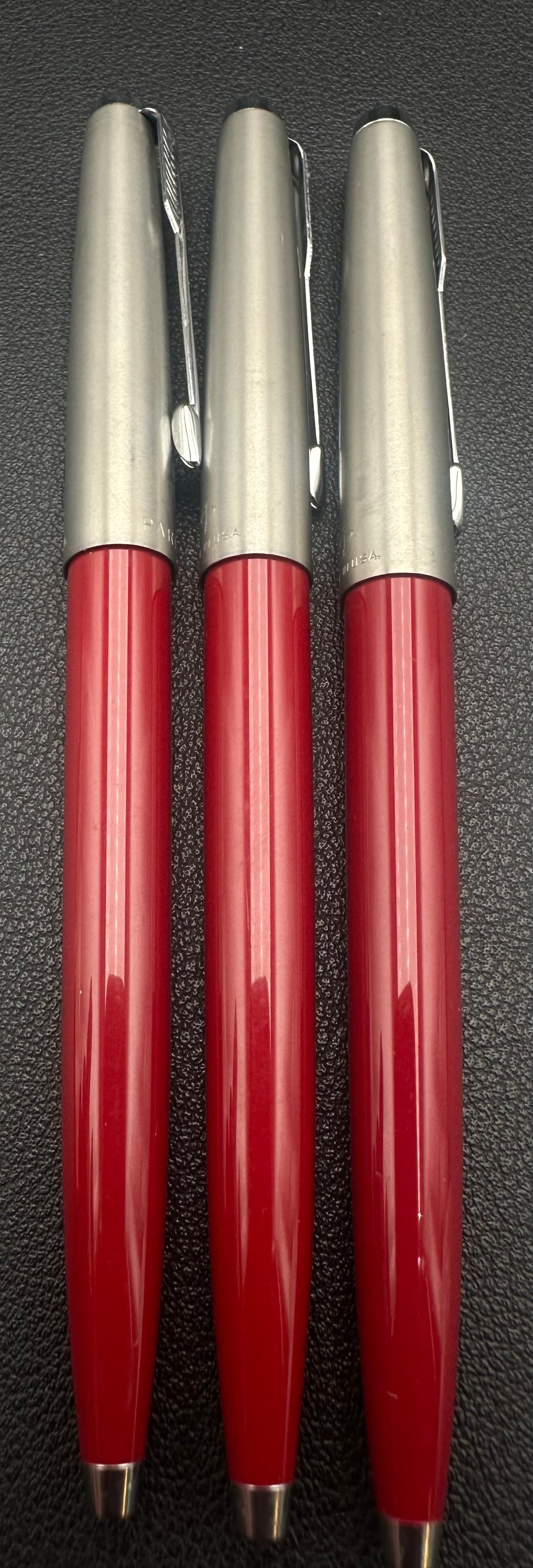 Parker 45 Flighter Red Ballpoint Pen Lot of 3 Stainless Steel: Lot of three vintage Parker 45 Flighter ballpoint pens featuring brushed stainless steel caps with chrome arrow clips and bright red plastic barrels. Made in the U.S.A. Classic mid-century Parker desi