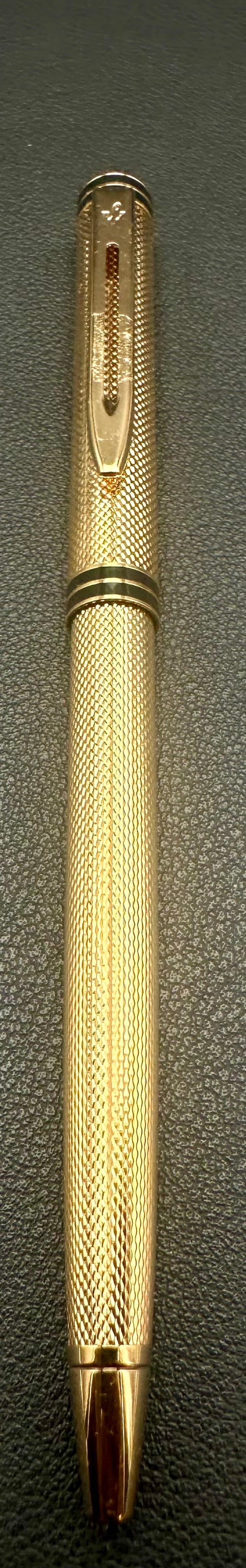 Waterman Gentleman Gold Plated Guilloché Ballpoint Pen Made in France: Elegant Waterman Gentleman twist-action ballpoint pen featuring a gold-plated engine-turned guilloché finish with black lacquer accent bands and the classic Waterman clip. Made in France, this premiu