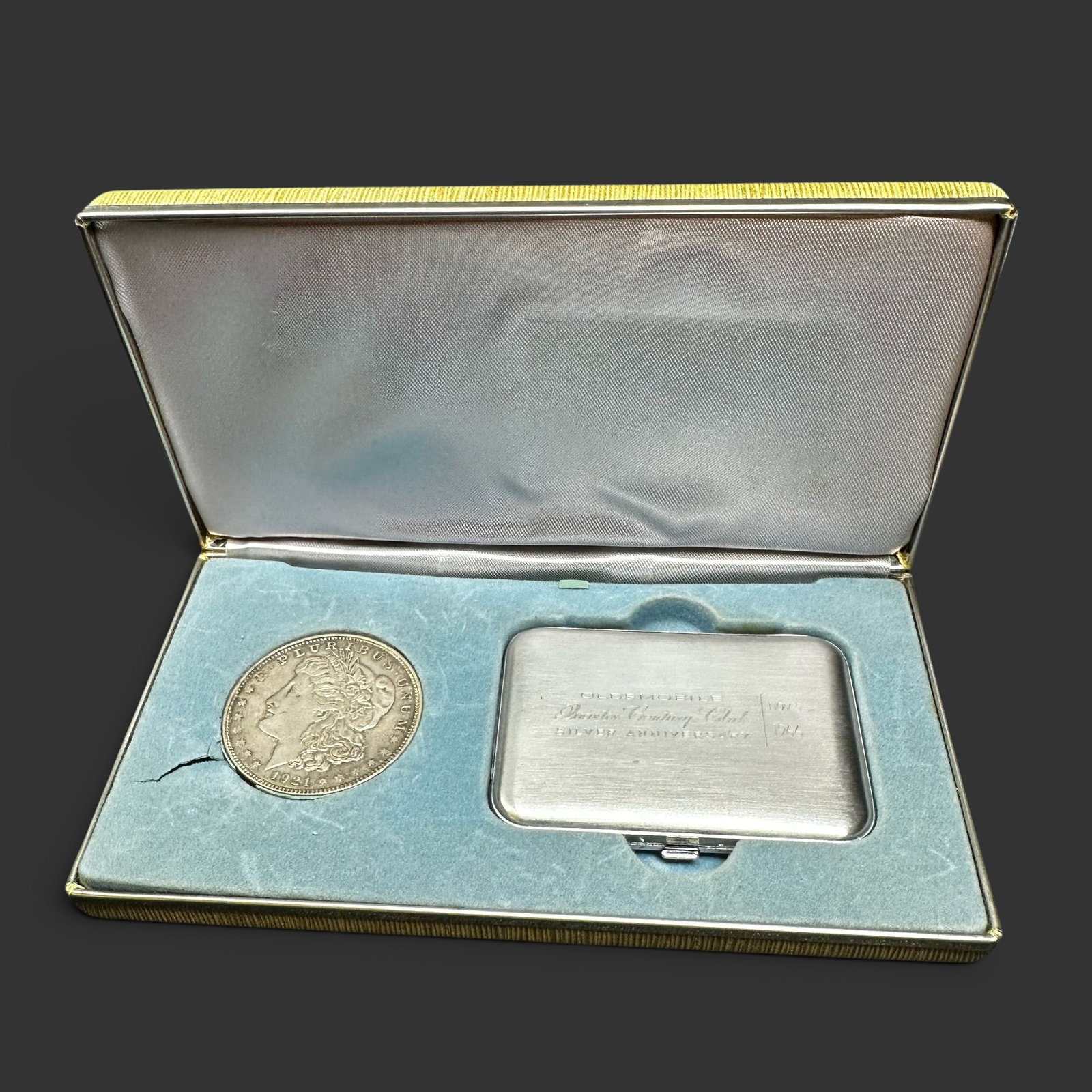 1921 Morgan Silver Dollar & Oldsmobile Compact Set: 1921 Morgan Silver Dollar & Oldsmobile Compact Set:Brand/Model: Oldsmobile Quarter Century Club Silver Anniversary compact case and United States Mint 1921 Morgan Silver Dollar.Manufacturer Location: 