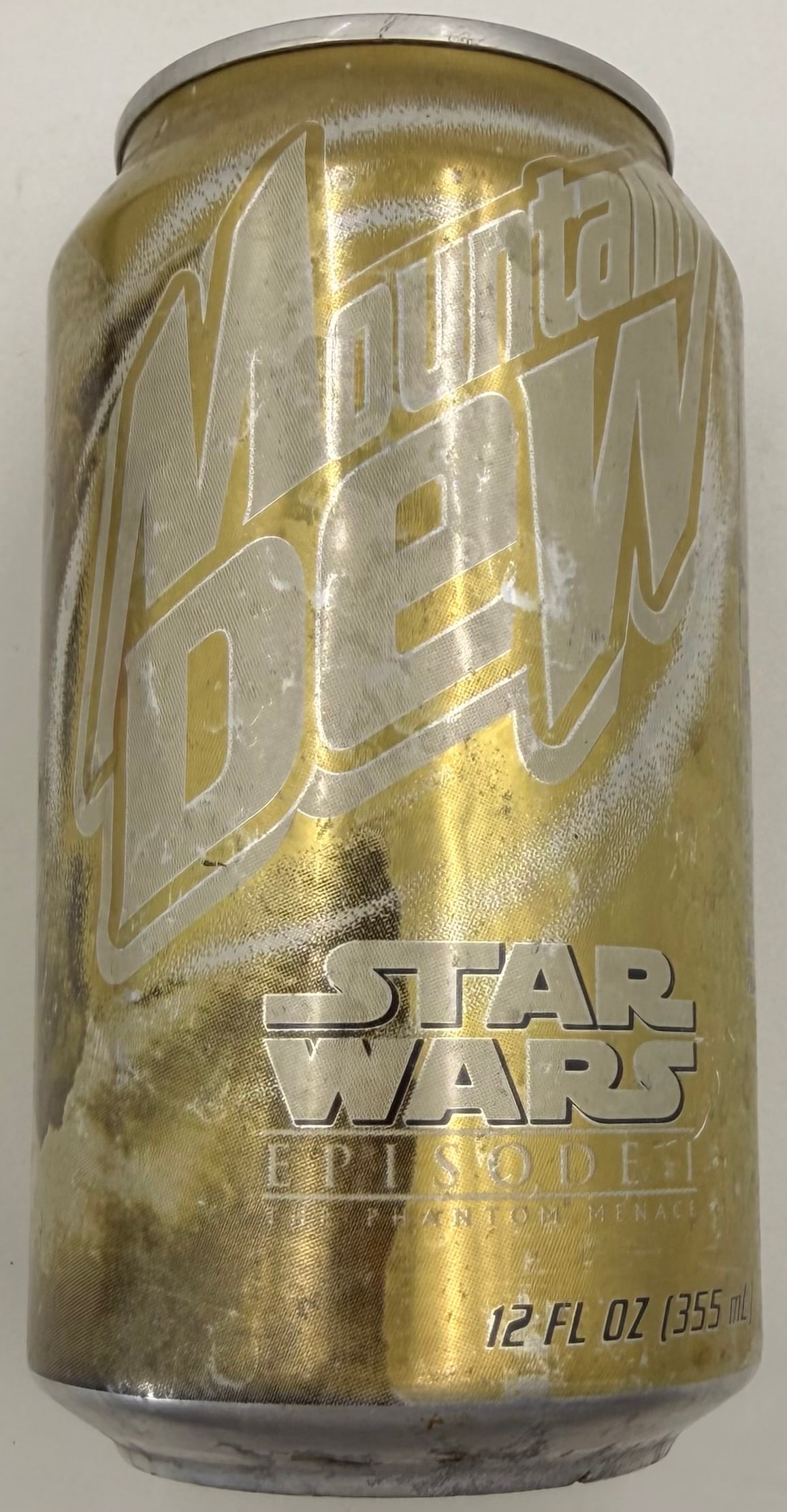 1999 Gold Yoda Mountain Dew Promo Can: This rare 1999 Mountain Dew “Gold Yoda” promotional 12 fl oz can was released for Star Wars: Episode I – The Phantom Menace. The gold-colored can was part of a national promotion in which