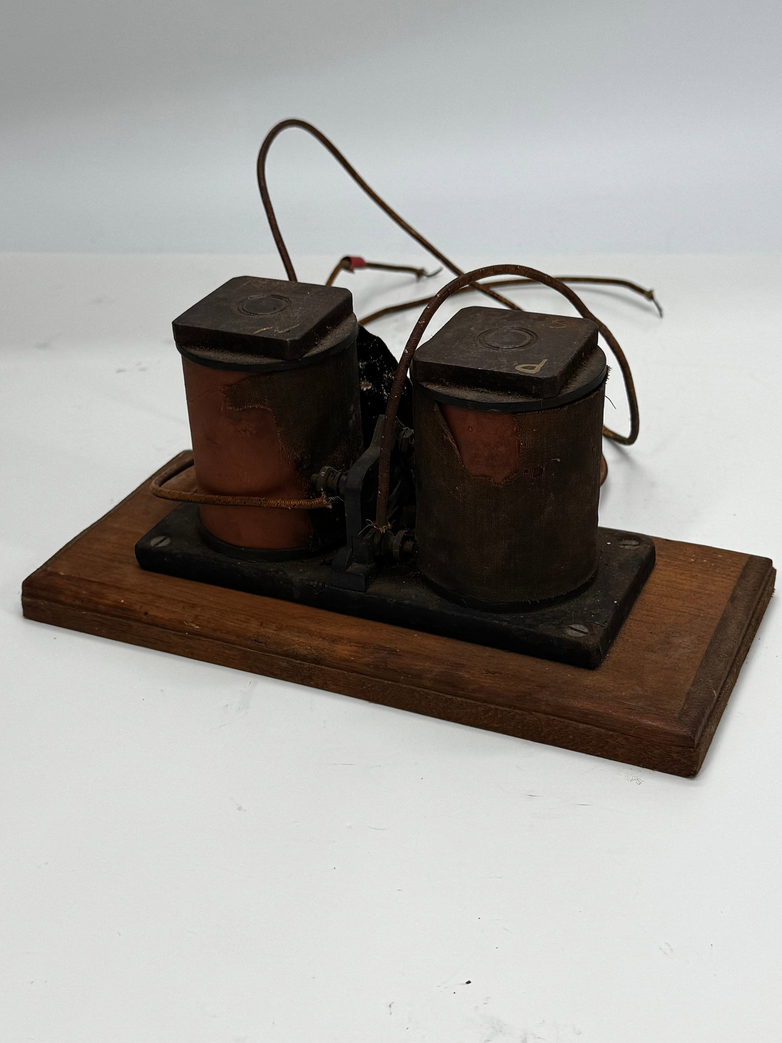 Antique Double Coil Telegraph Relay Electromagnet c.1900: Antique double-coil electromagnetic relay or telegraph sounder mounted on its original wooden base, dating to approximately 1880–1910. Features twin wire-wound coils, iron armature, cloth-covered wi