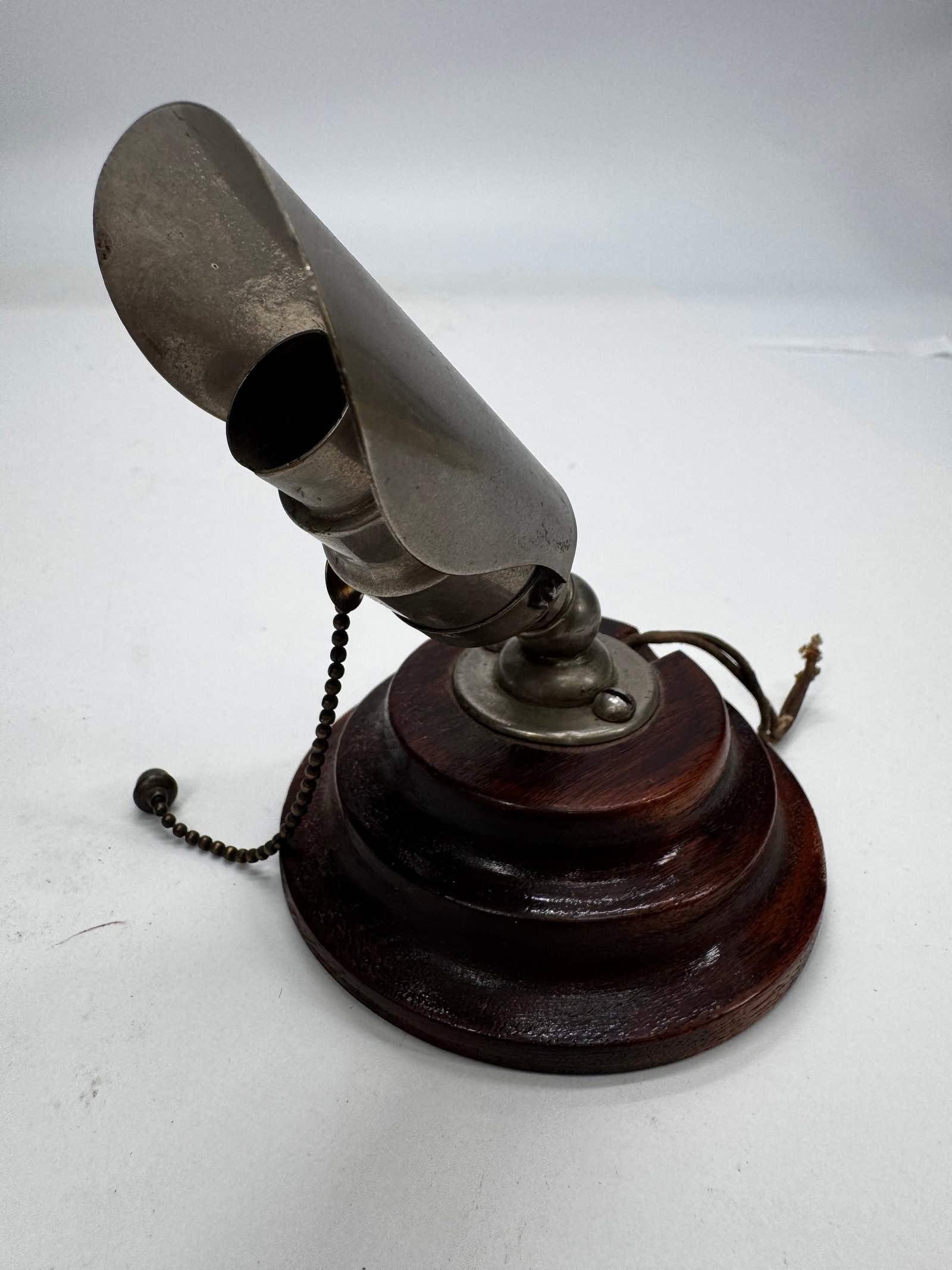 Vintage Adjustable Nickel Spotlight Lamp on Wood Base Pull Chain: Vintage adjustable spotlight or inspection lamp with a nickel-plated metal shade mounted on a turned hardwood base. Features an adjustable ball-joint swivel and original pull-chain light socket. Likel
