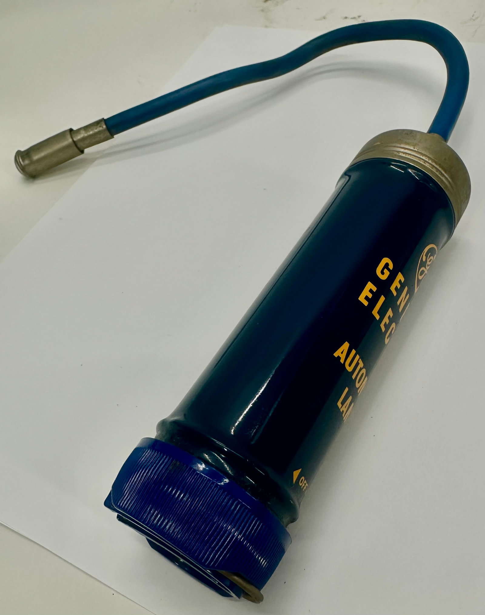 Vintage GE General Electric Automotive Lamps Dispenser: Vintage General Electric (GE) Automotive Lamps countertop bulb dispenser featuring the classic blue painted metal body, original GE logo, flexible rubber dispensing hose, and metal fittings. Designed 