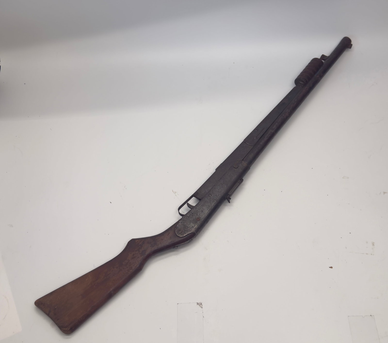 Vintage Daisy No. 104 Pump Action BB Air Rifle: Vintage Daisy No. 104 pump-action BB air rifle with wood stock and forearm, blued steel barrel and receiver. Shows heavy age-related wear, oxidation, and finish loss consistent with long-term use. Unt