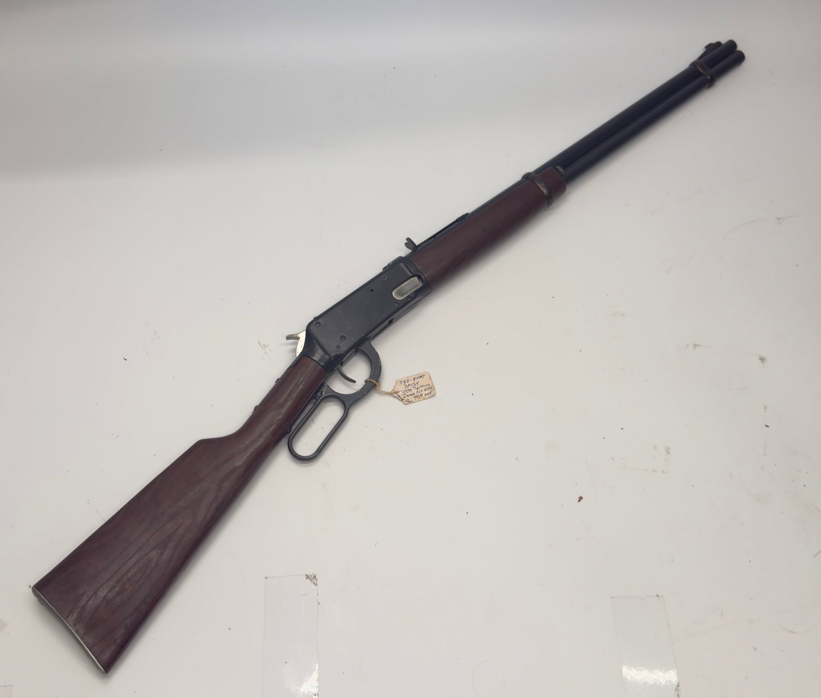 1894 Daisy “Spitting Image” Cast Iron Air Rifle: Rare 1894 Daisy “Spitting Image” cast iron air rifle featuring a lever-action design, blued steel barrel, and wood stock and forearm. Includes an identification tag noting “1894 Spitting Ima